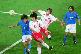 South Korean midfielder Ahn Jung-hwan (2nd L) heads the ball past Italian defender Paolo Maldini (L-#3) for a 'golden goal' in their second round match at the 2002 FIFA World Cup Korea/Japan in Daejeon, 18 June 2002.  South Korea won the match 2-1 in extr