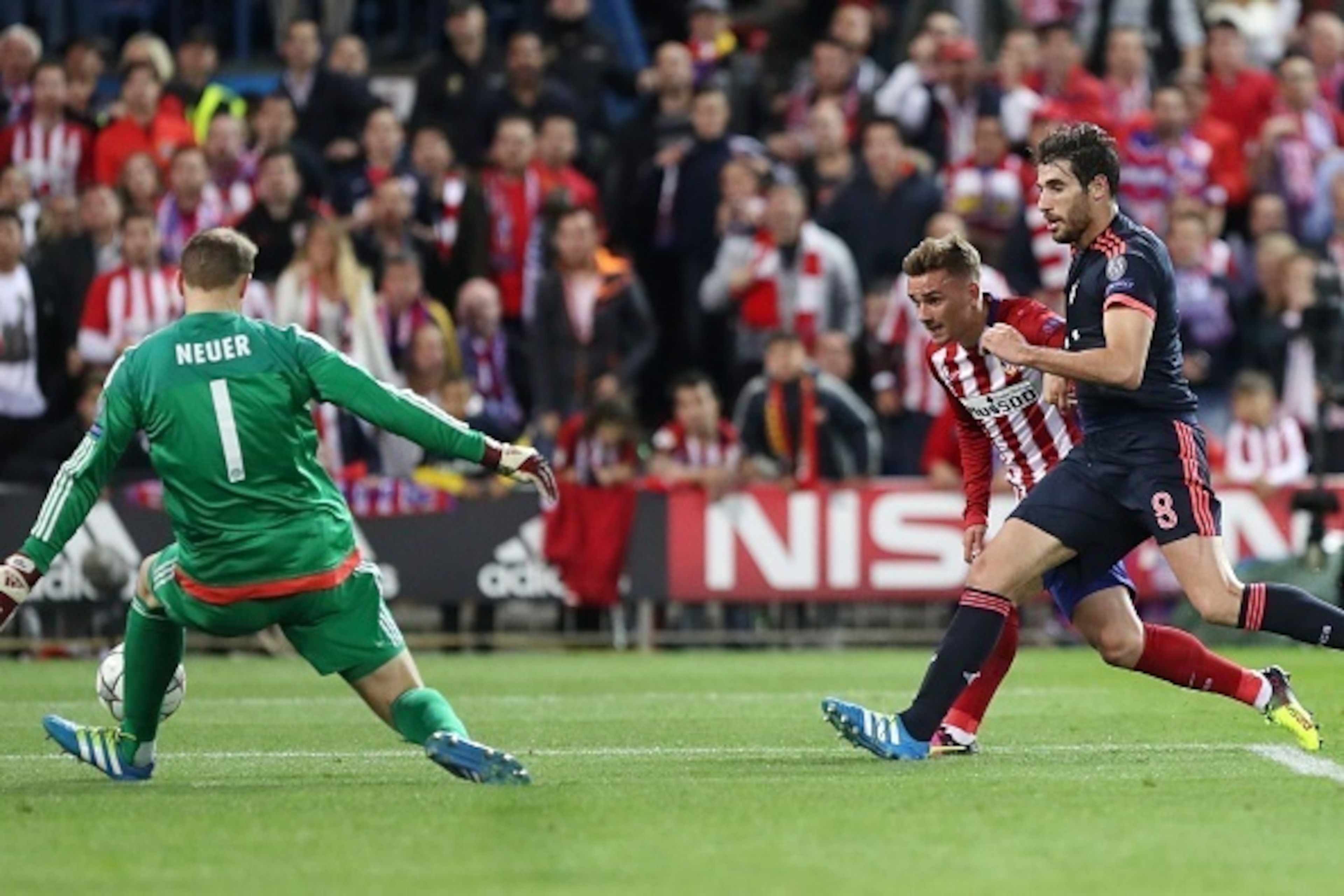 Atletico Madrid's French forward Antoine Griezmann (C) vies with Bayern Munich's goalkeeper Manuel Neuer (L) and Bayern Munich's Spanish midfielder Xabi Alonso during the UEFA Champions League semi-final first leg football match Club Atletico de Madrid vs