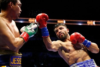 SAN ANTONIO,TX - DECEMBER 12: Victor Ortiz(R) punches Gilberto Sanches-Leon during their Welterweight bout at AT&T Center on December 12, 2015 in San Antonio,Texas.  (Photo by Ronald Cortes/Getty Images)