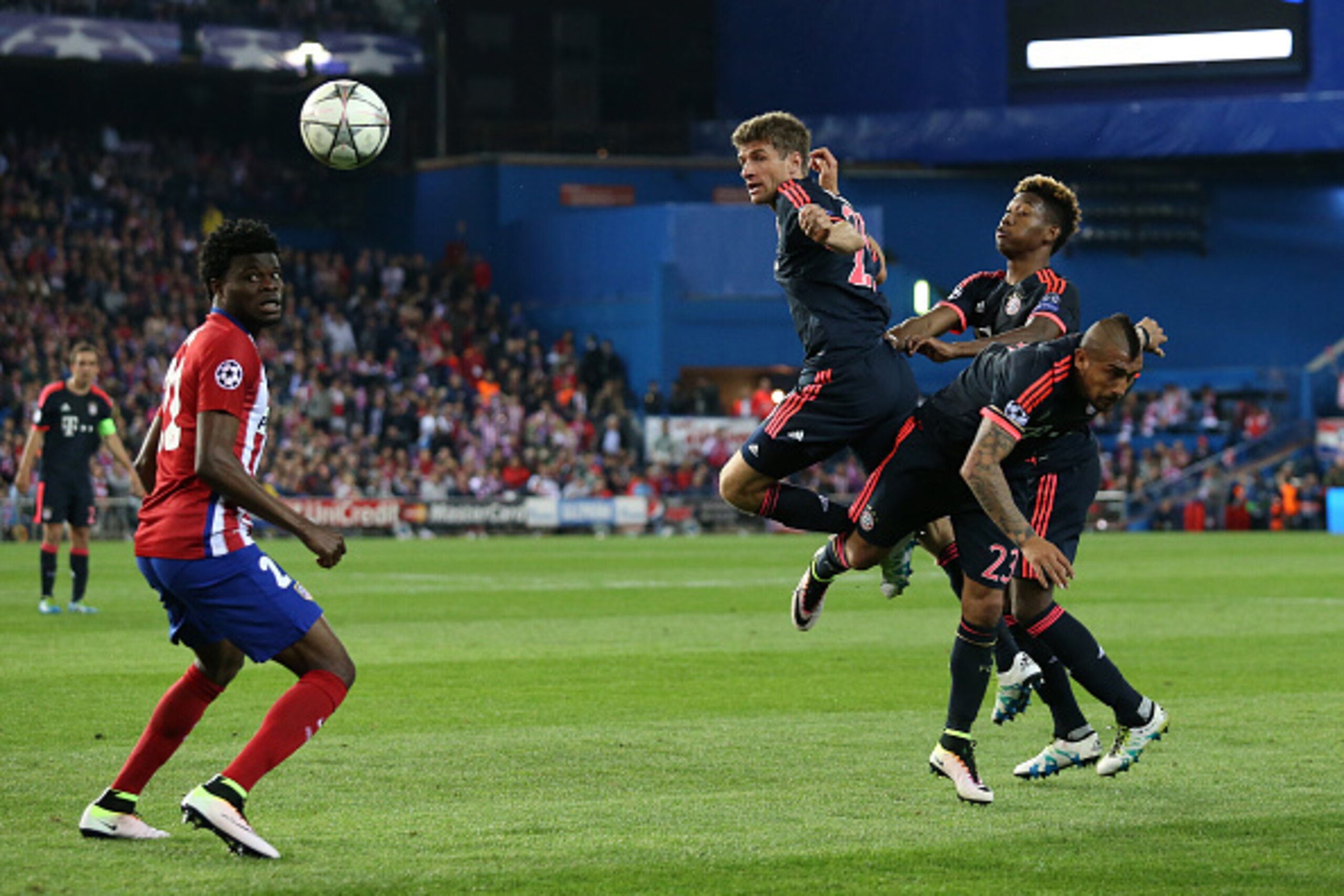 MADRID, SPAIN - APRIL 27: Thomas Muller, Arturo Vidal and David Alaba of Bayern Munich fight for the ball while Thomas Partey of Atletico Madrid looks on during the UEFA Champions League semi final first leg match between Club Atletico Madrid and FC Bayer