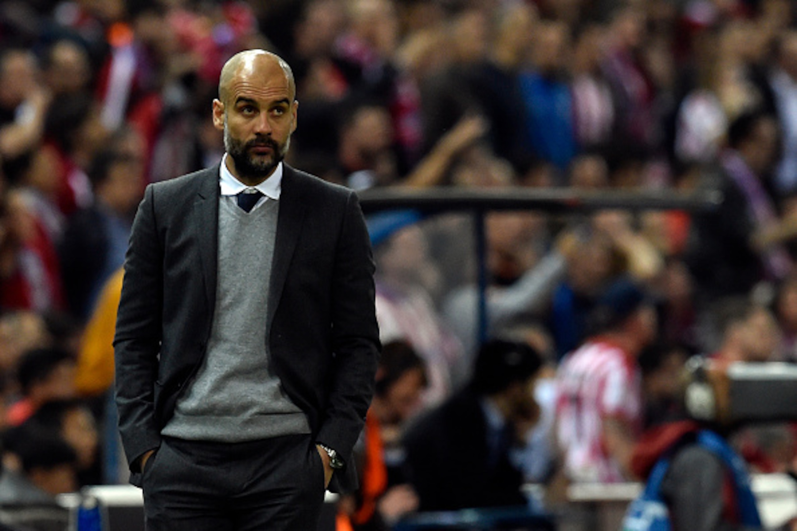 Bayern Munich's Spanish head coach Pep Guardiola stands during the UEFA Champions League semi-final first leg football match Club Atletico de Madrid vs Bayern Munich at the Vicente Calderon stadium in Madrid on April 27, 2016. / AFP / GERARD JULIEN       