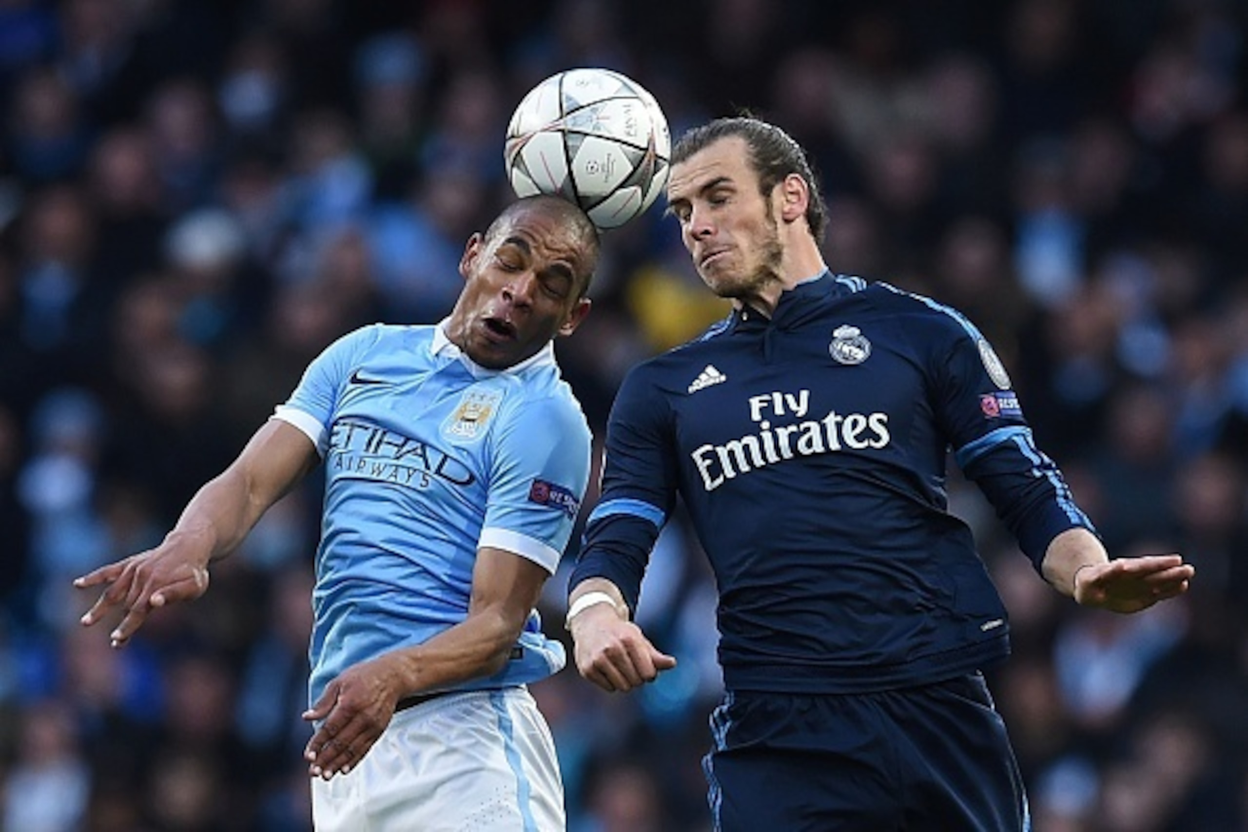 Real Madrid's Welsh forward Gareth Bale (R) and Manchester City's Brazilian midfielder Fernando (L) go up for a high ball during the UEFA Champions League semi-final first leg football match between Manchester City and Real Madrid at the Etihad Stadium in