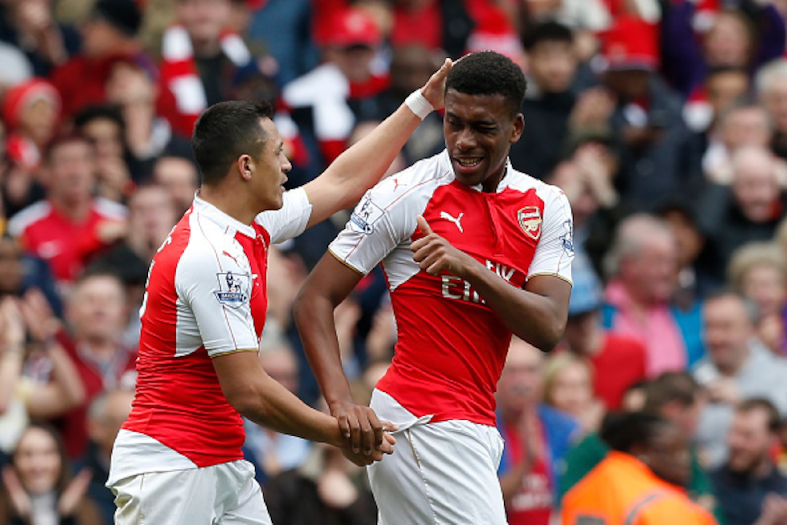 Arsenal's Nigerian striker Alex Iwobi (R) celebrates with Arsenal's Chilean striker Alexis Sanchez after scoring during the English Premier League football match between Arsenal and Watford at the Emirates Stadium in London on April 2, 2016.  / AFP / Ian 