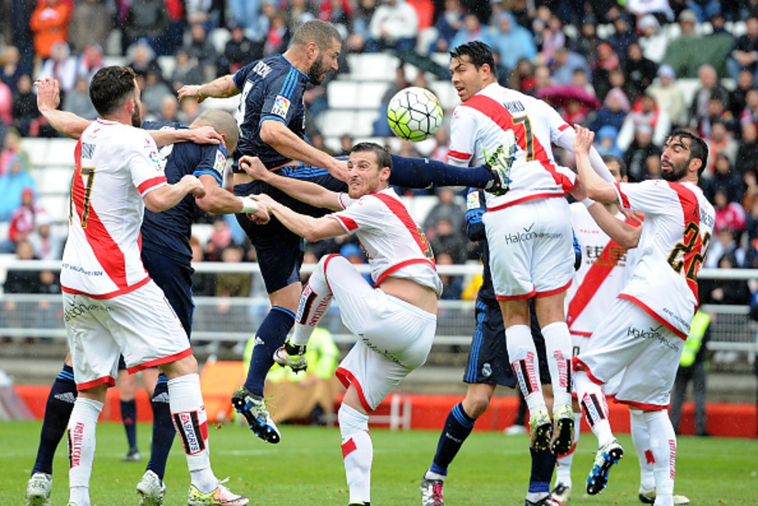 MADRID, SPAIN - APRIL 23:  Karim Benzema of Real Madrid goes for a high ball against Quini Marin of Rayo Vallecano de Madrid during the La Liga match between Rayo Vallecano and Real Madrid at Estadio de Vallecas on April 23, 2016 in Madrid, Spain.  (Photo