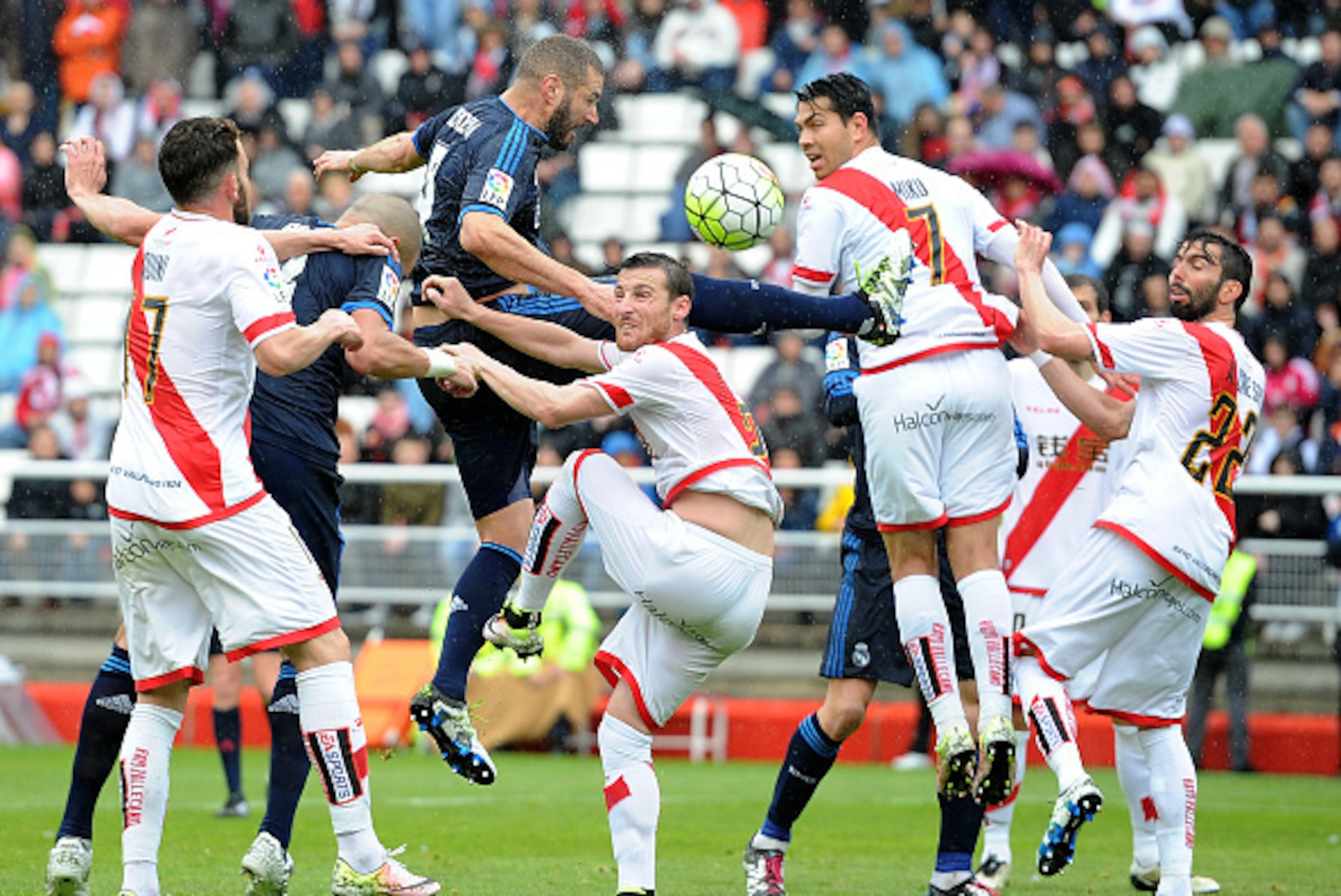 MADRID, SPAIN - APRIL 23:  Karim Benzema of Real Madrid goes for a high ball against Quini Marin of Rayo Vallecano de Madrid during the La Liga match between Rayo Vallecano and Real Madrid at Estadio de Vallecas on April 23, 2016 in Madrid, Spain.  (Photo