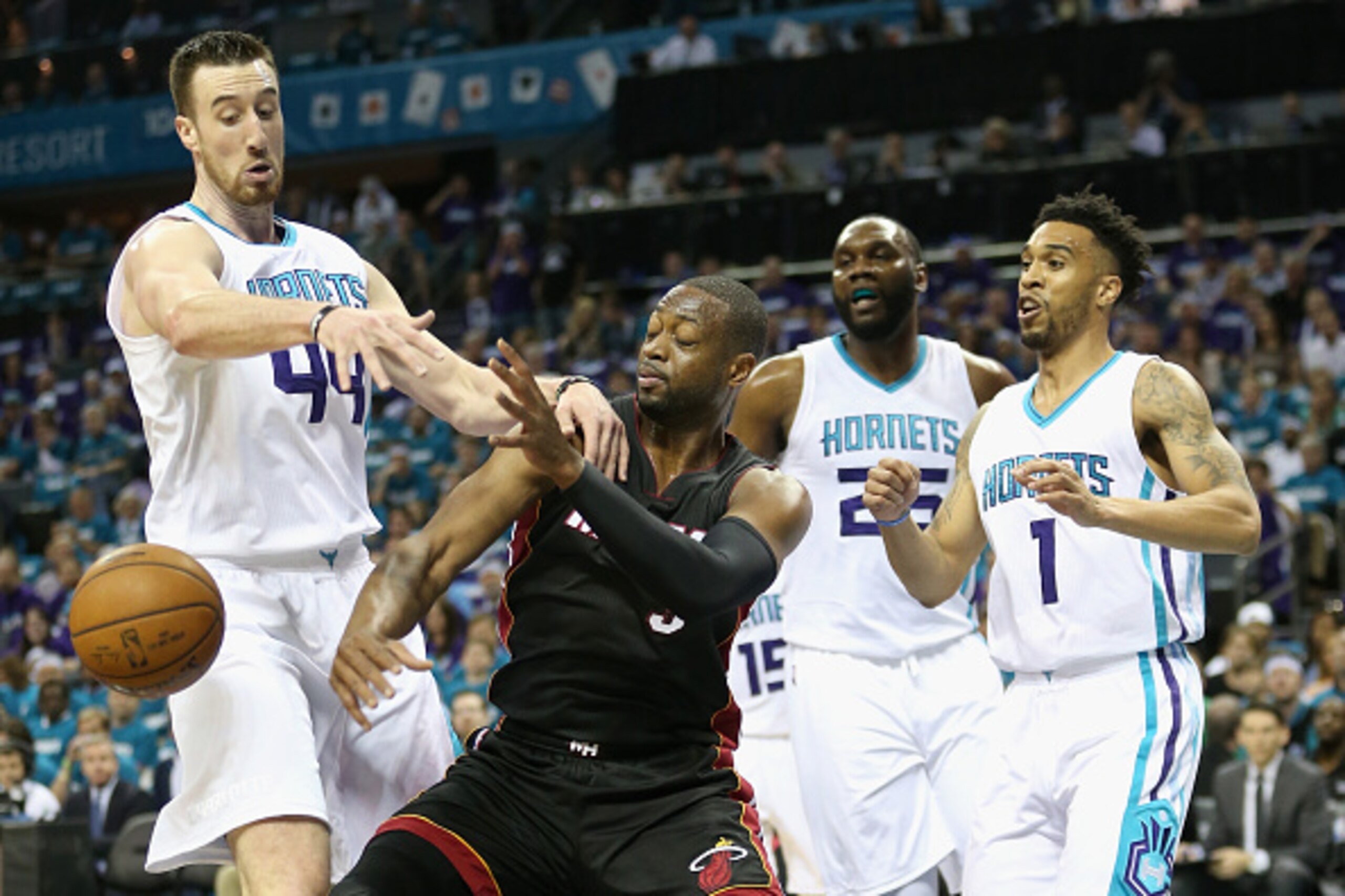 CHARLOTTE, NC - APRIL 25:  Dwyane Wade #3 of the Miami Heat battles for a loose ball against Frank Kaminsky #44 as teammates Al Jefferson #25 and Courtney Lee #1 of the Charlotte Hornets watch on during game four of the Eastern Conference Quarterfinals of