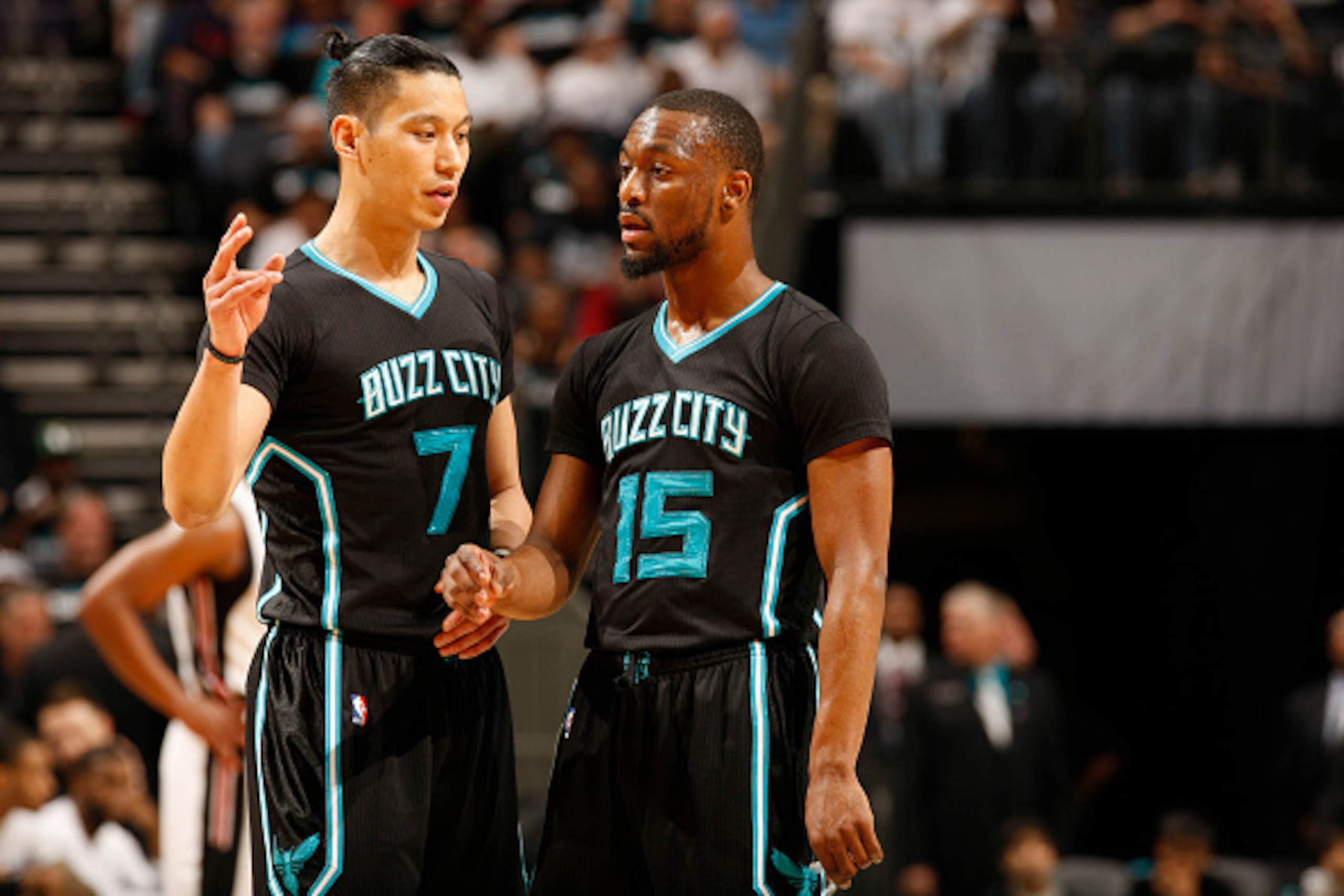 CHARLOTTE, NC  - APRIL 23: Jeremy Lin #7 and Kemba Walker #15 of the Charlotte Hornets discuss during Game Three of the Eastern Conference Quarterfinals during the 2016 NBA Playoffs against the Miami Heat on April 23, 2016 at Time Warner Cable Arena in Ch