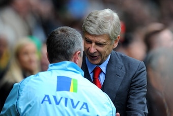 NORWICH, ENGLAND - MAY 11: Neil Adams, manager of Norwich City shakes hands with Arsene Wenger manager of Arsenal  during the Barclays Premier League match between Norwich City and Arsenal at Carrow Road on May 11, 2014 in Norwich, England.  (Photo by Ste