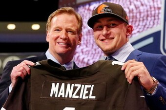 NEW YORK, NY - MAY 08:  Johnny Manziel of the Texas A&M Aggies poses with NFL Commissioner Roger Goodell after he was picked #22 overall by the Cleveland Browns during the first round of the 2014 NFL Draft at Radio City Music Hall on May 8, 2014 in New Yo