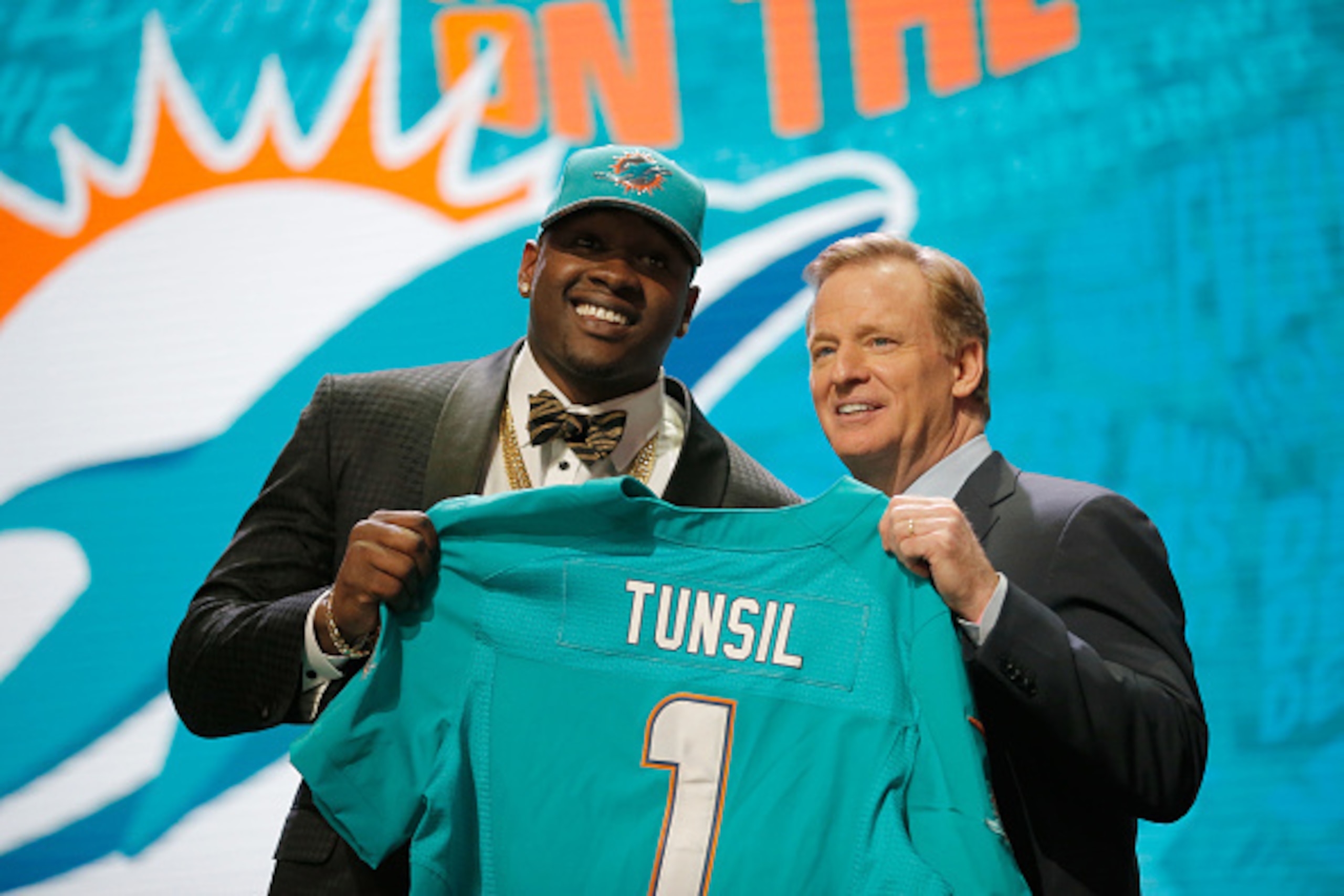 CHICAGO, IL - APRIL 28:  (L-R) Laremy Tunsil of Ole Miss holds up a jersey with NFL Commissioner Roger Goodell after being picked #13 overall by the Miami Dolphins during the first round of the 2016 NFL Draft at the Auditorium Theatre of Roosevelt Univers