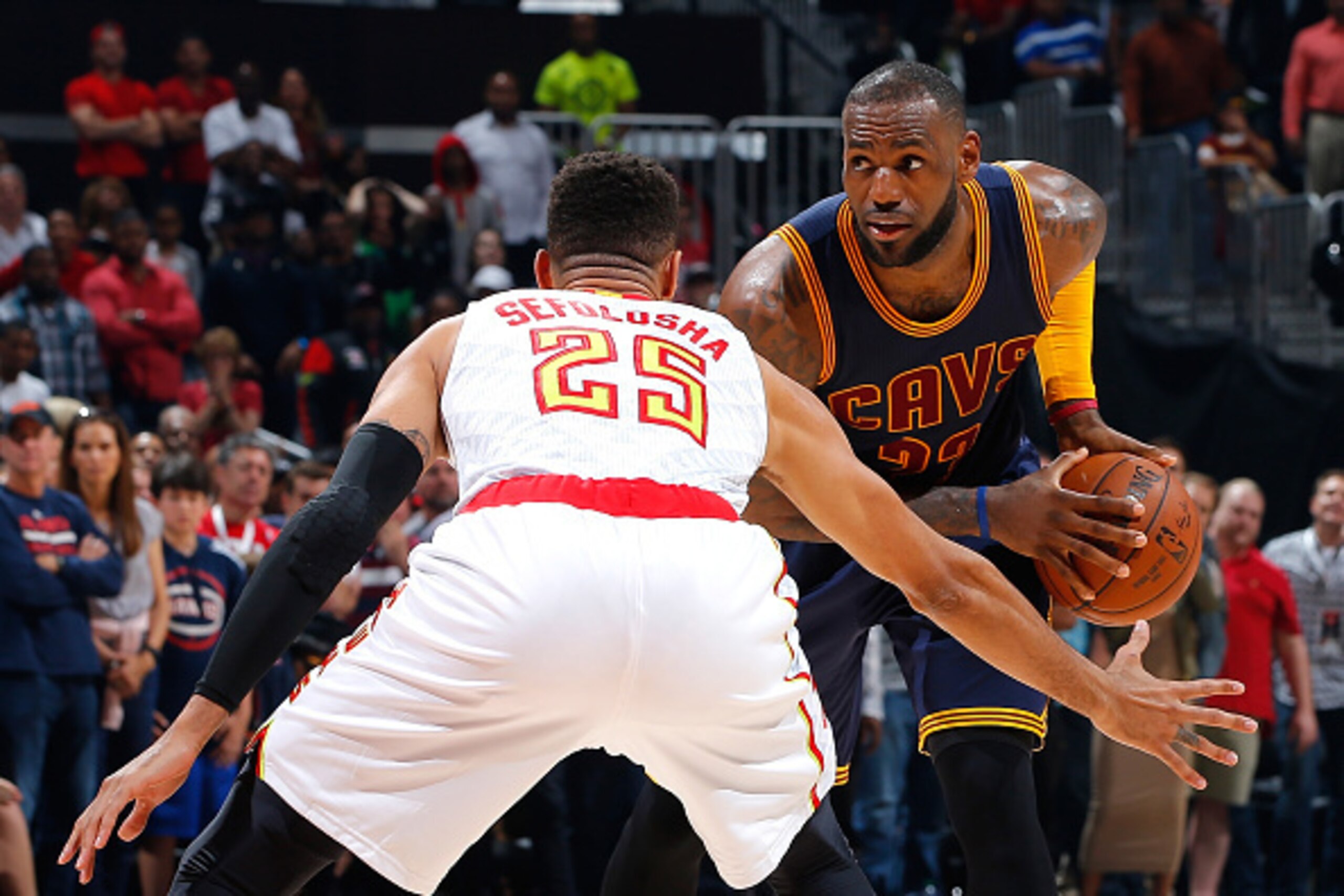 ATLANTA, GEORGIA - APRIL 01:  LeBron James #23 of the Cleveland Cavaliers looks to drive against Thabo Sefolosha #25 of the Atlanta Hawks at Philips Arena on April 1, 2016 in Atlanta, Georgia.  NOTE TO USER User expressly acknowledges and agrees that, by 