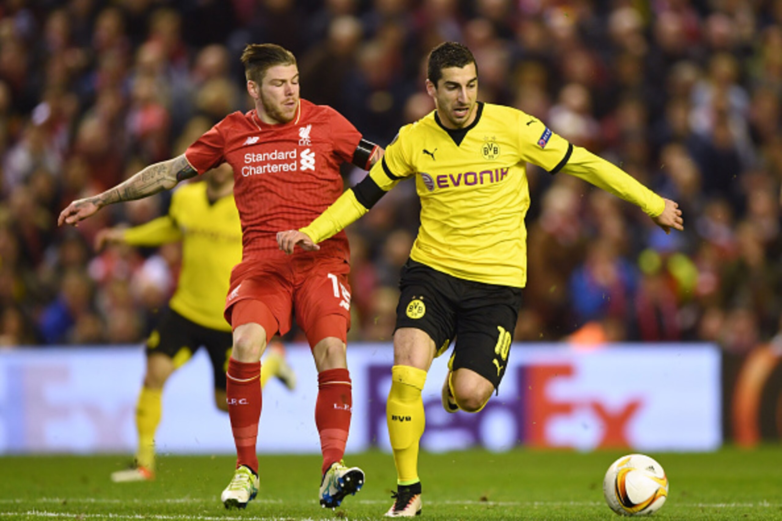 LIVERPOOL, ENGLAND - APRIL 14:  Henrikh Mkhitaryan of Borussia Dortmund is challenged by Alberto Moreno of Liverpool during the UEFA Europa League quarter final, second leg match between Liverpool and Borussia Dortmund at Anfield on April 14, 2016 in Live