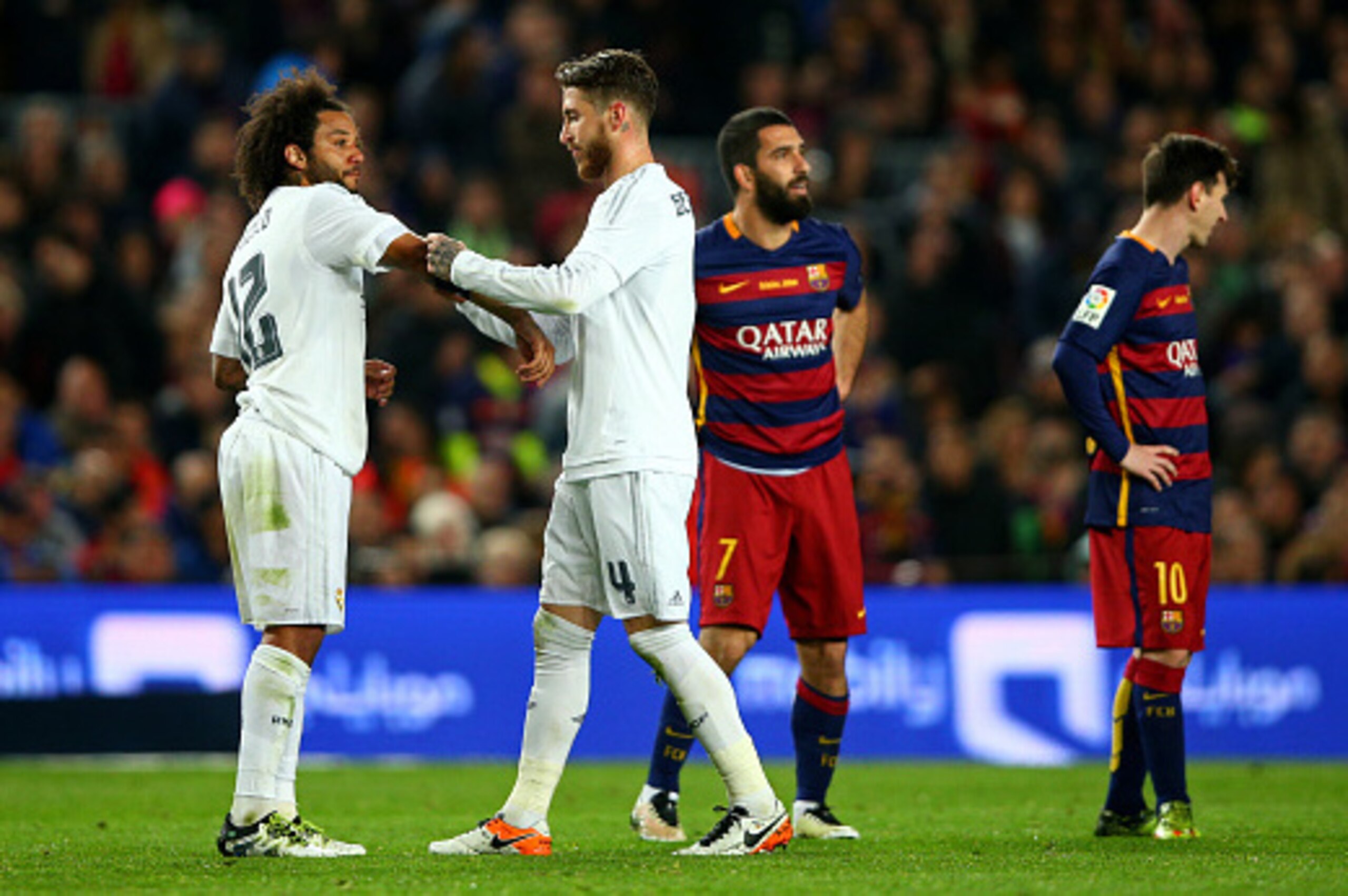 BARCELONA, SPAIN - APRIL 02:  Sergio Ramos of Real Madrid CF passes the captain's armband to Marcelo of Real Madrid CF after receiving a red card during the La Liga match between FC Barcelona and Real Madrid CF at Camp Nou on April 2, 2016 in Barcelona, S