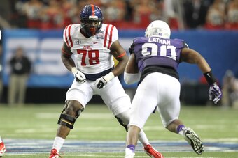 Dec 31, 2014; Atlanta , GA, USA; Mississippi Rebels offensive lineman Laremy Tunsil (78) prepares to block TCU Horned Frogs defensive tackle Terrell Lathan (90) during the first quarter in the 2014 Peach Bowl at the Georgia Dome. Mandatory Credit: Brett D