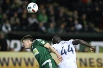 Feb 24, 2016; Portland, OR, USA; Portland Timbers midfielder Ben Zemanski (14) reacts after Vancouver Whitecaps FC defender Pa Modou Kah (44) heads the all over him at Providence Park. Mandatory Credit: Jaime Valdez-USA TODAY Sports