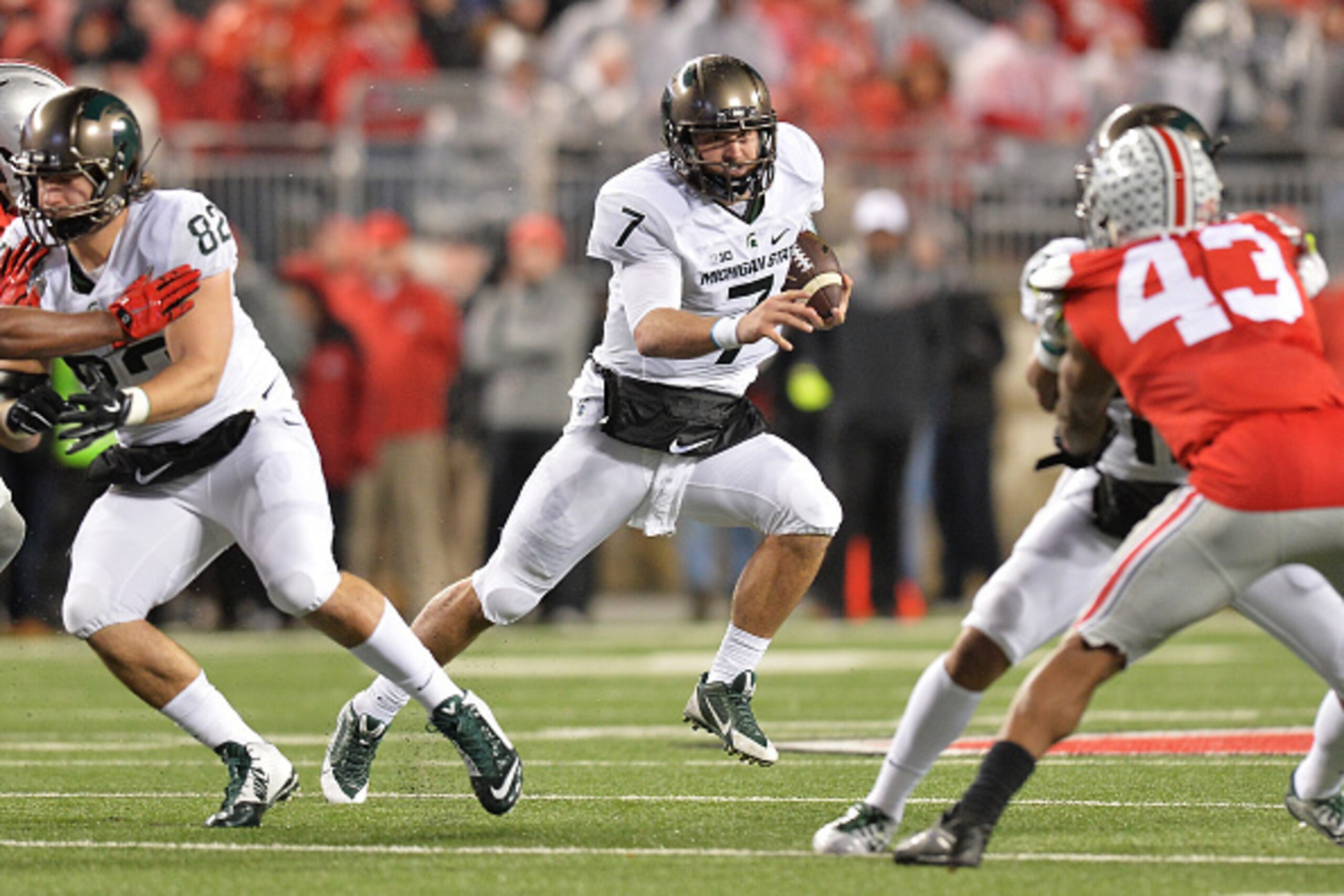 COLUMBUS, OH - NOVEMBER 21:  Quarterback Tyler O'Connor #7 of the Michigan State Spartans looks for running room in the third quarter against the Ohio State Buckeyes at Ohio Stadium on November 21, 2015 in Columbus, Ohio. Michigan State defeated Ohio Stat