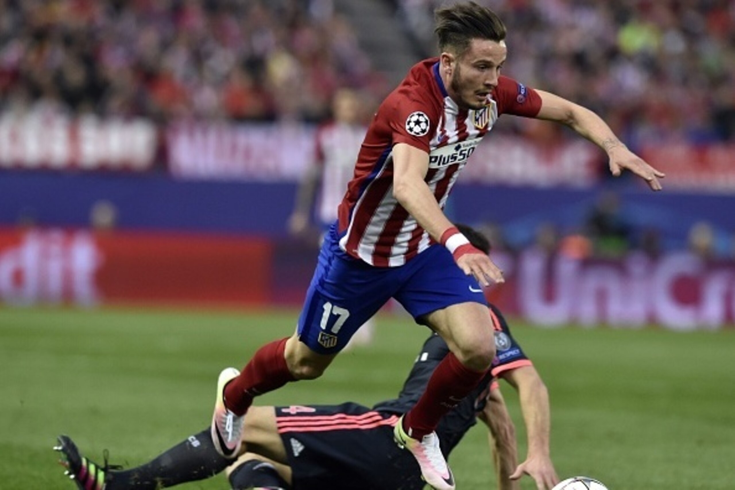 Atletico Madrid's midfielder Saul Niguez jumps over another player during the UEFA Champions League semi-final first leg football match Club Atletico de Madrid vs Bayern Munich at the Vicente Calderon stadium in Madrid on April 27, 2016. / AFP / GERARD JU