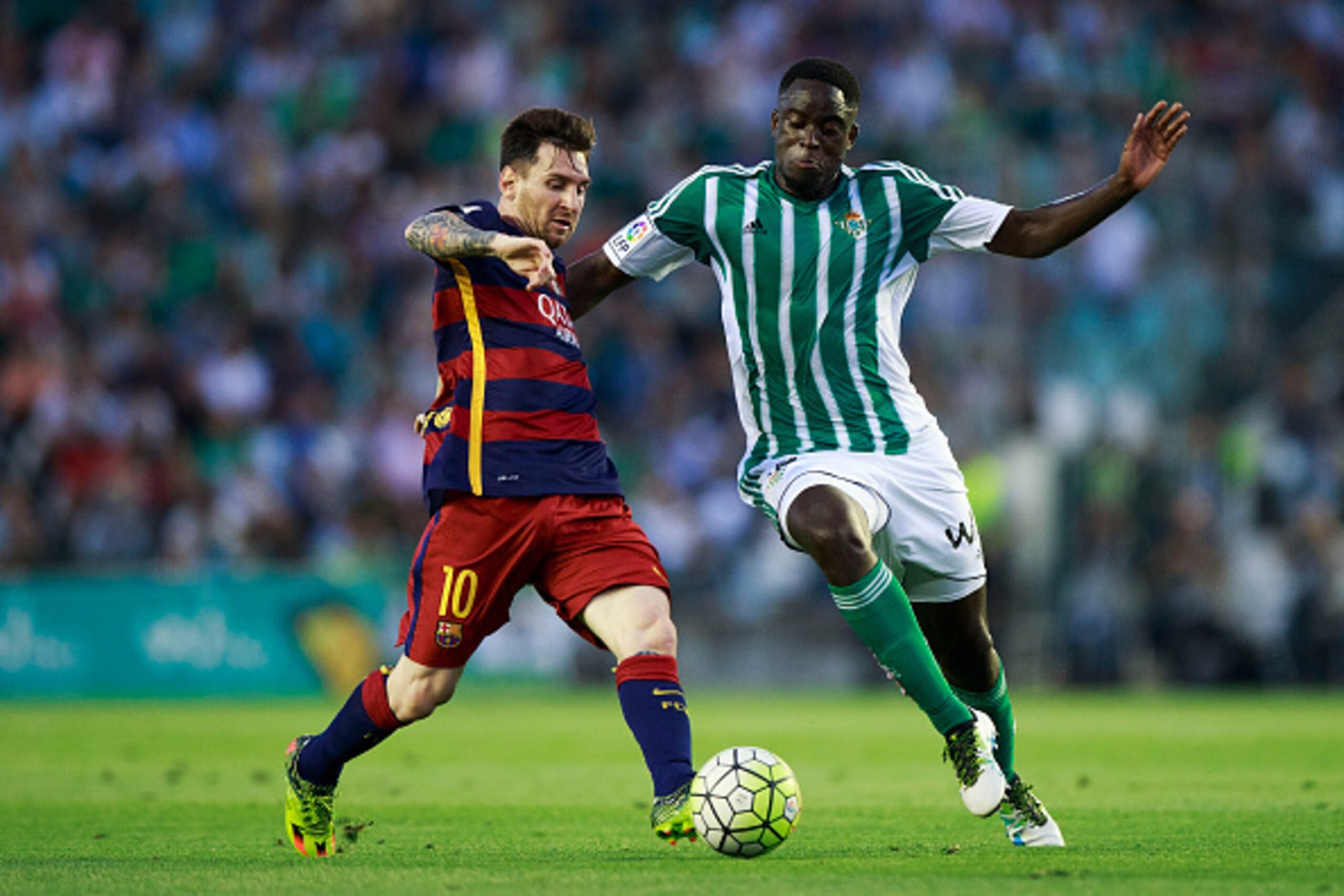 SEVILLE, SPAIN - APRIL 30:  Lionel Messi (L) of FC Barcelona competes for the ball with Alfred N Diaye (R) of Real Betis Balompie during the La Liga match between Real Betis Balompie and FC Barcelona at Estadio Benito Villamarin on April 30, 2016 in Sevil