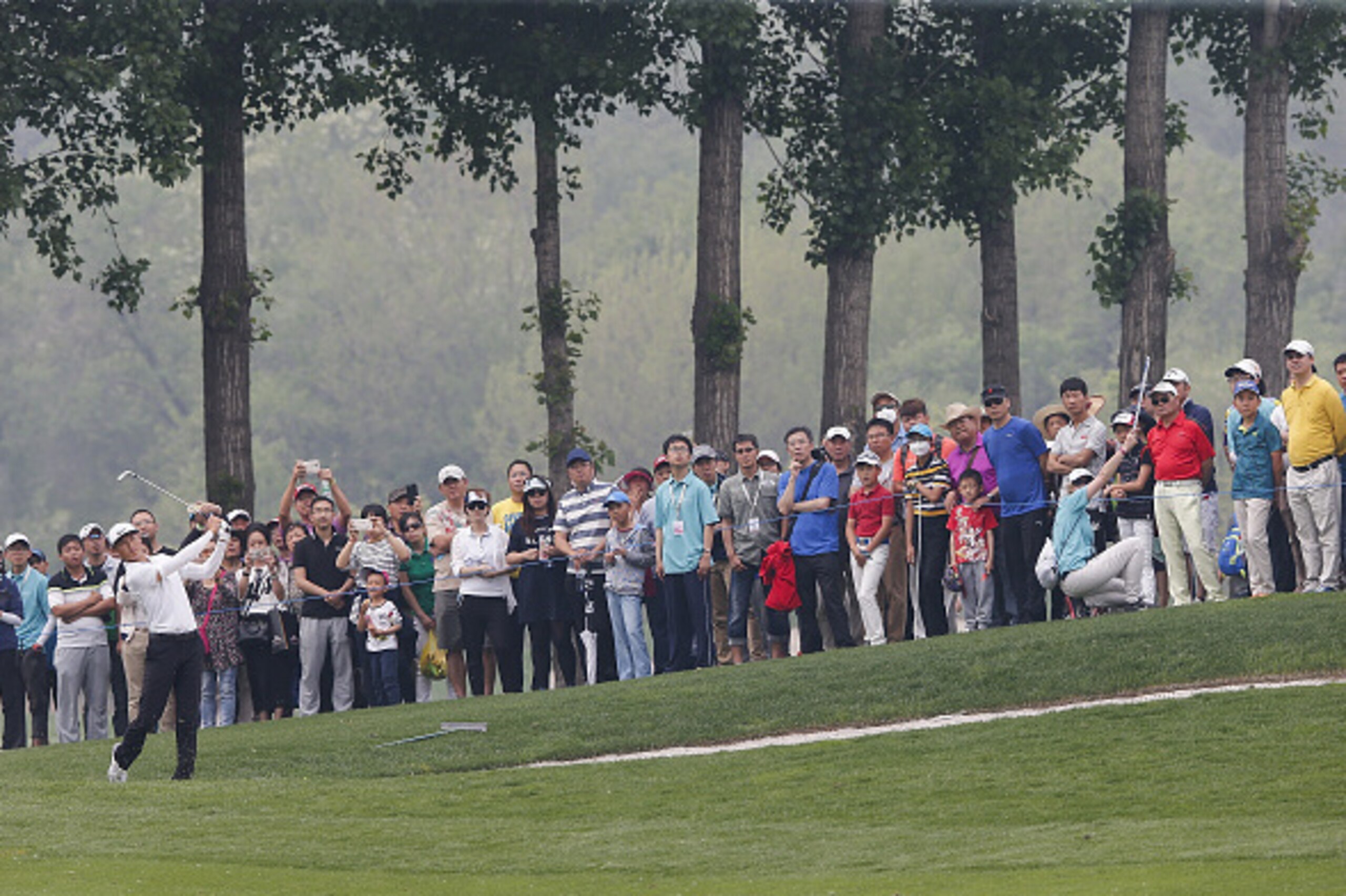 BEIJING, CHINA - MAY 01: Li Haotong of China plays a shot during the final round of the Volvo China open at Topwin Golf and Country Club on May 1, 2016 in Beijing, China.  (Photo by Lintao Zhang/Getty Images)