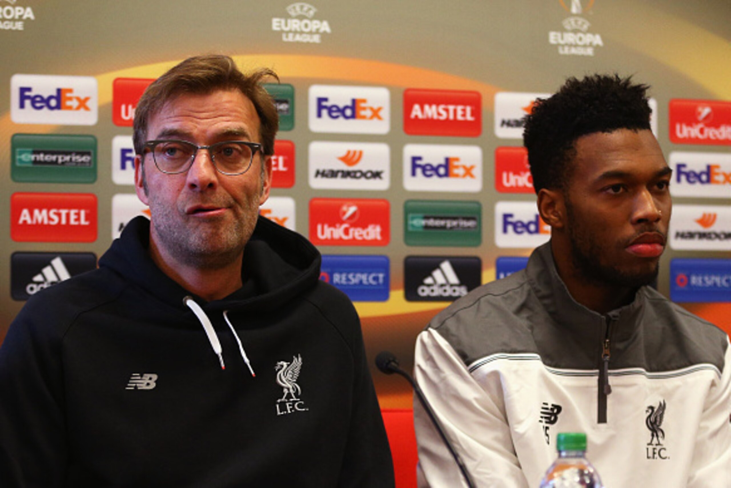 LIVERPOOL, ENGLAND - FEBRUARY 24:  Jurgen Klopp manager of Liverpool and Daniel Sturridge look on during a Liverpool press conference ahead of their UEFA Europa League round of 32 second leg match against FC Augsburg at Melwood Training Ground on February