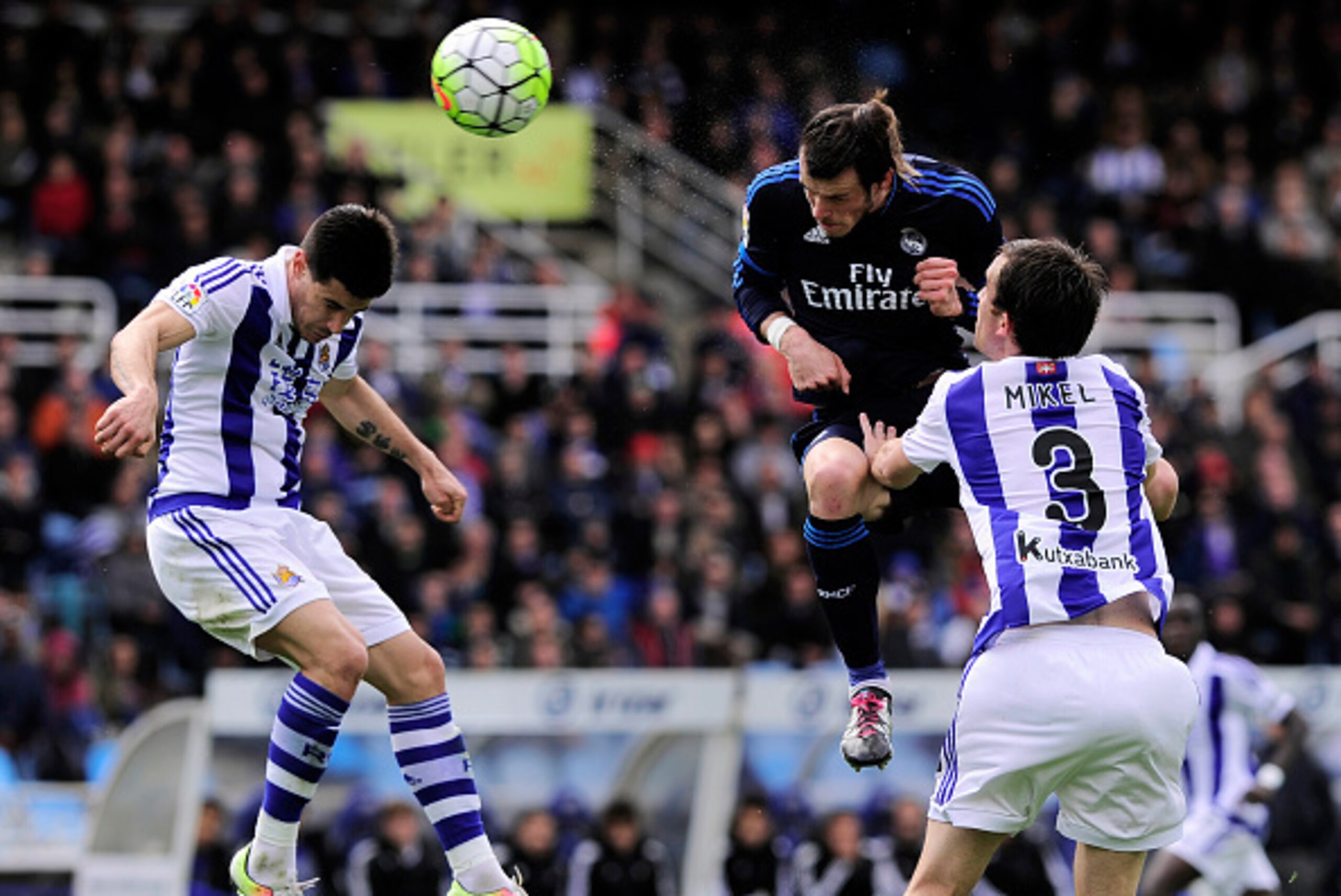 Real Madrid's Welsh forward Gareth Bale (C) vies with Real Sociedad's defender Yuri Berchiche (L) and defender Mikel Gonzalez (R) during the Spanish league football match Real Sociedad de Futbol vs Real Madrid CF at the Anoeta stadium in San Sebastian on 