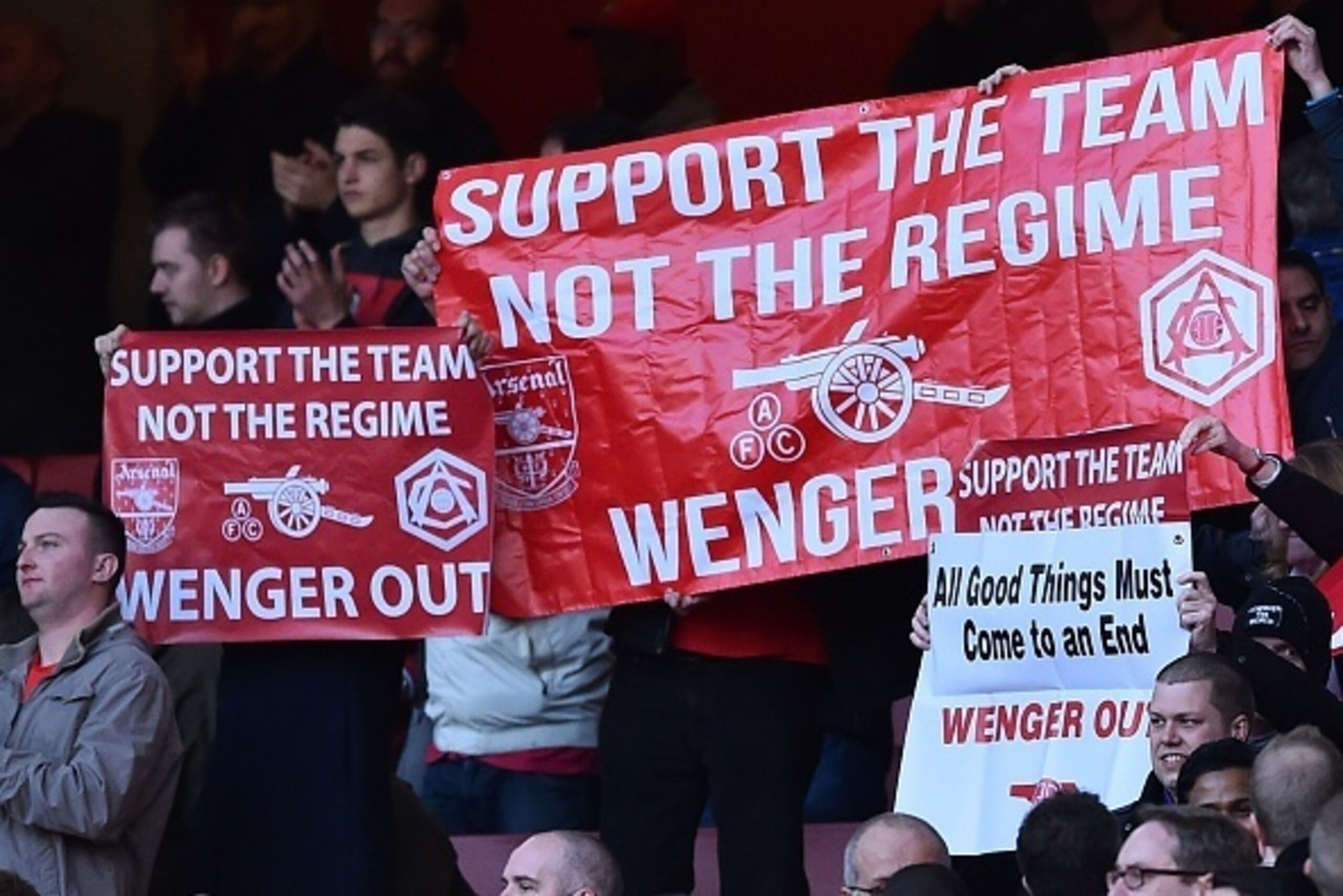 Arsenal fans hold up banners calling for 'Wenger Out', referring to Arsenal's French manager Arsene Wenger, during the English Premier League football match between Arsenal and Norwich at the Emirates Stadium in London on April 30, 2016.  / AFP / BEN STAN