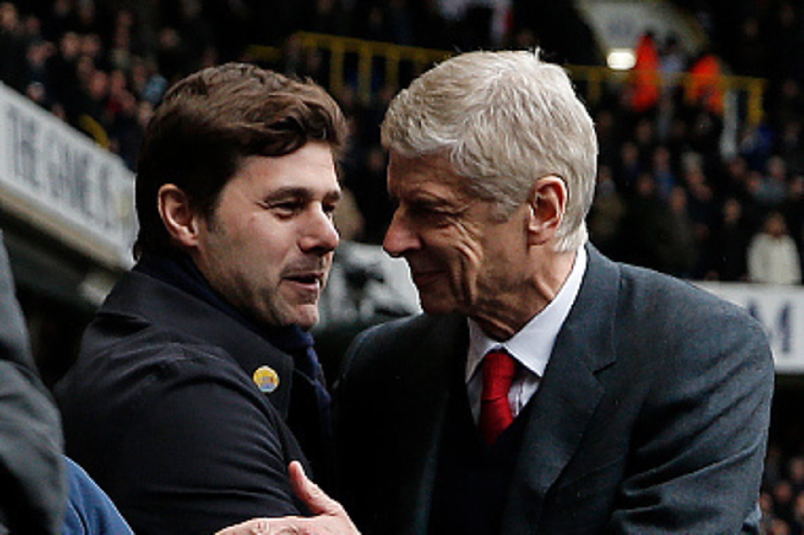 Tottenham Hotspur's Argentinian head coach Mauricio Pochettino (L) shakes hands with Arsenal's French manager Arsene Wenger ahead of the English Premier League football match between Tottenham Hotspur and Arsenal at White Hart Lane in London, on March 5, 
