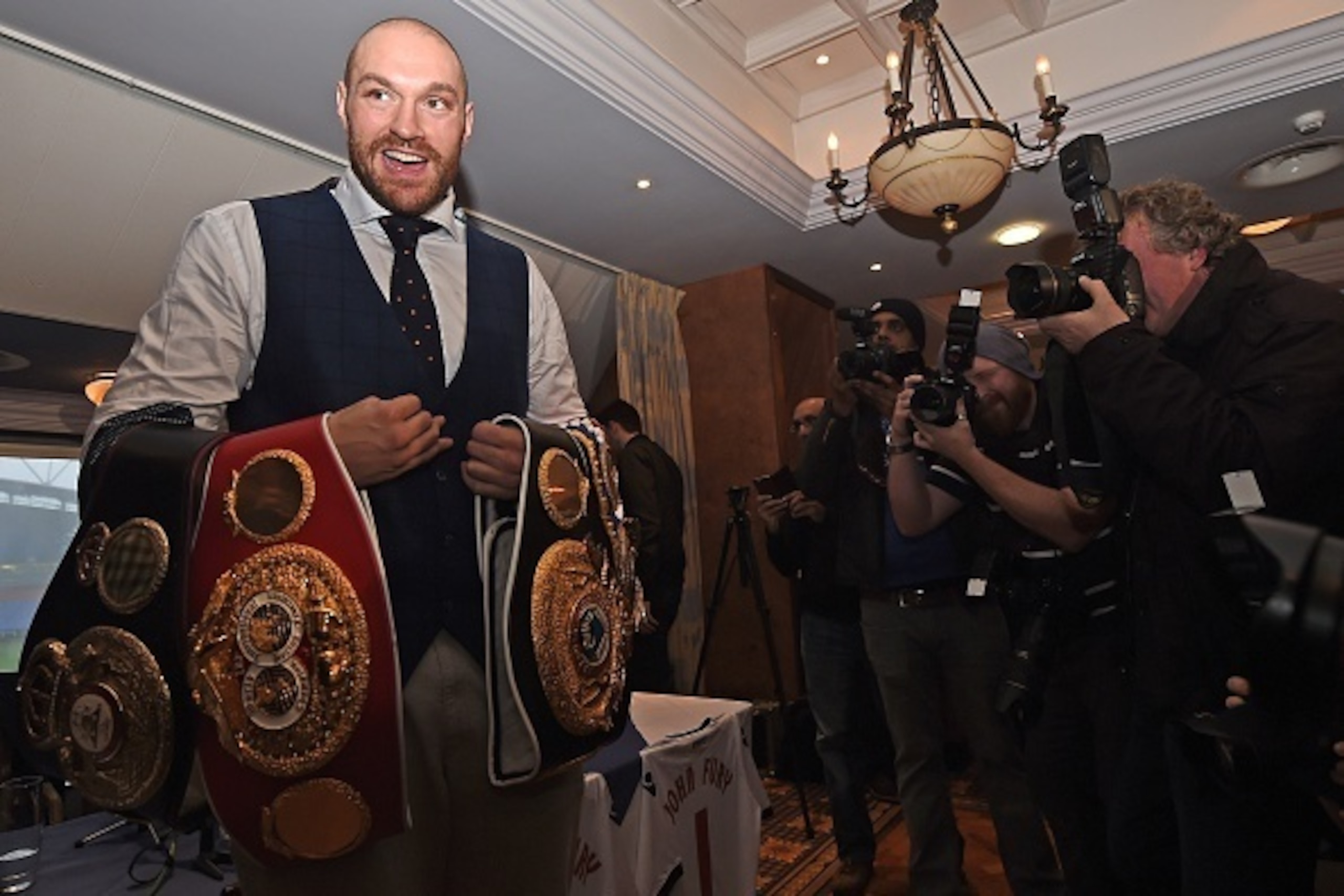 Britain's world heavyweight champion Tyson Fury poses with championship belts during a press conference in Bolton, north west England on November 30, 2015. Tyson Fury was crowned the new world heavyweight champion on November 28, ending Wladimir Klitschko