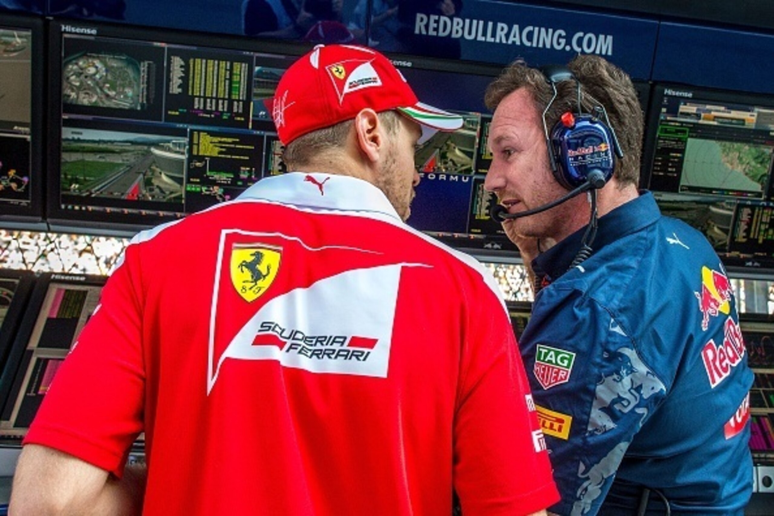 Scuderia Ferrari's German driver Sebastian Vettel (L) talks to Red Bull Racing Team Principal Christian Horner in the pits during the Formula One Russian Grand Prix at the Sochi Autodrom circuit on May 1, 2016.  / AFP / POOL / Srdjan Suki        (Photo cr