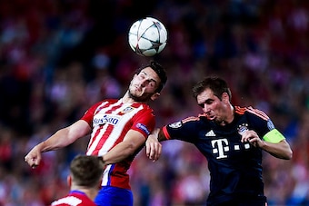 MADRID, SPAIN - APRIL 27: Koke of Atletico de Madrid wins the header after Philipp Lahm of Bayern Munich during the UEFA Champions League Semi Final first leg match between Club Atletico de Madrid and FC Bayern Muenchen at Vincente Calderon Stadium on Apr