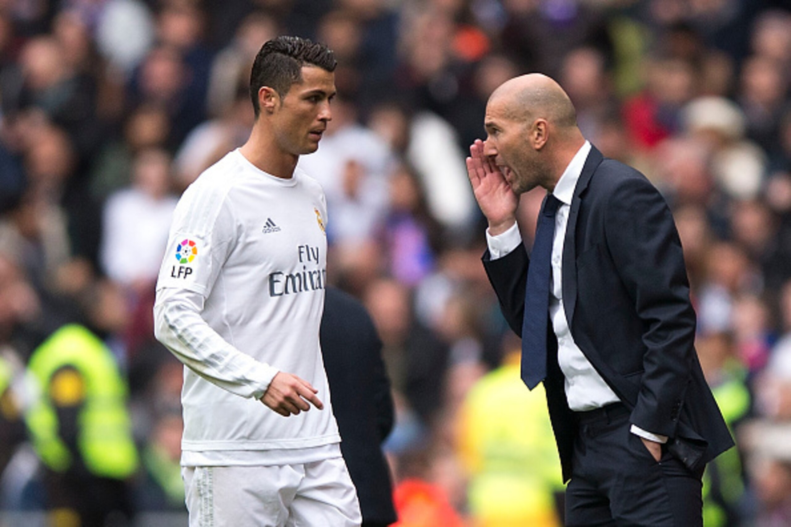 MADRID, SPAIN - FEBRUARY 13: coach Zinedine Zidane (R) of Real Madrid CF gives instructions to his player Cristiano Ronaldo  (L) during the La Liga match between Real Madrid CF and Athletic Club at Estadio Santiago Bernabeu on February 13, 2016 in Madrid,