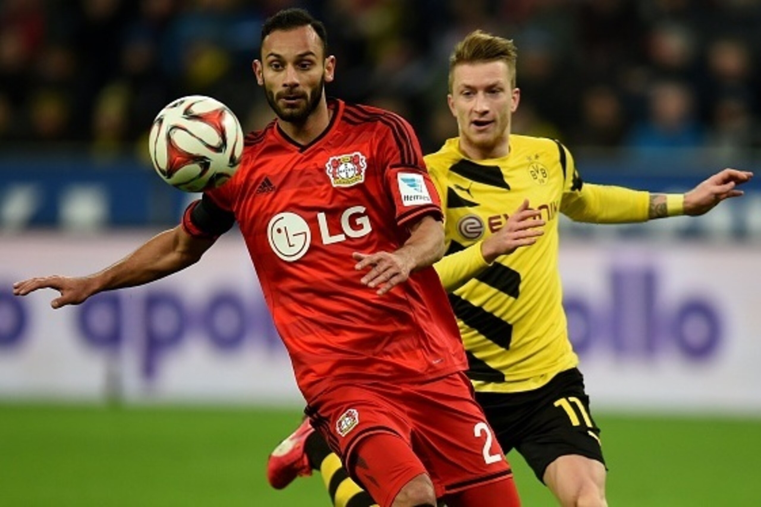 Dortmund's striker Marco Reus (R) and Leverkusen's Turkish defender Oemer Toprak vie for the ball during the German first division Bundesliga football match Bayer 04 Leverkusen vs Borussia Dortmund in Leverkusen, western Germany on January 31, 2015. The m