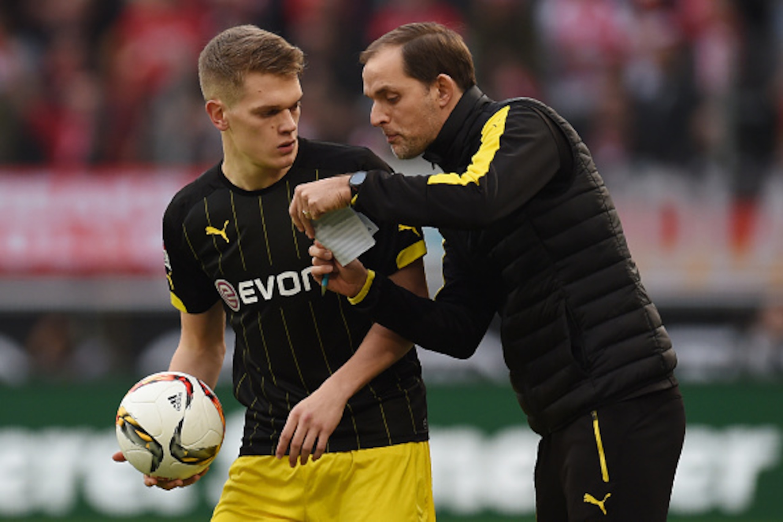 Dortmund's defender Matthias Ginter (L) speaks with Dortmund's head coach Thomas Tuchel during the German first division Bundesliga football match 1 FC Cologne vs Borussia Dortmund in Cologne, western Germany, on December 19, 2015. 

 / AFP / PATRIK STOLL
