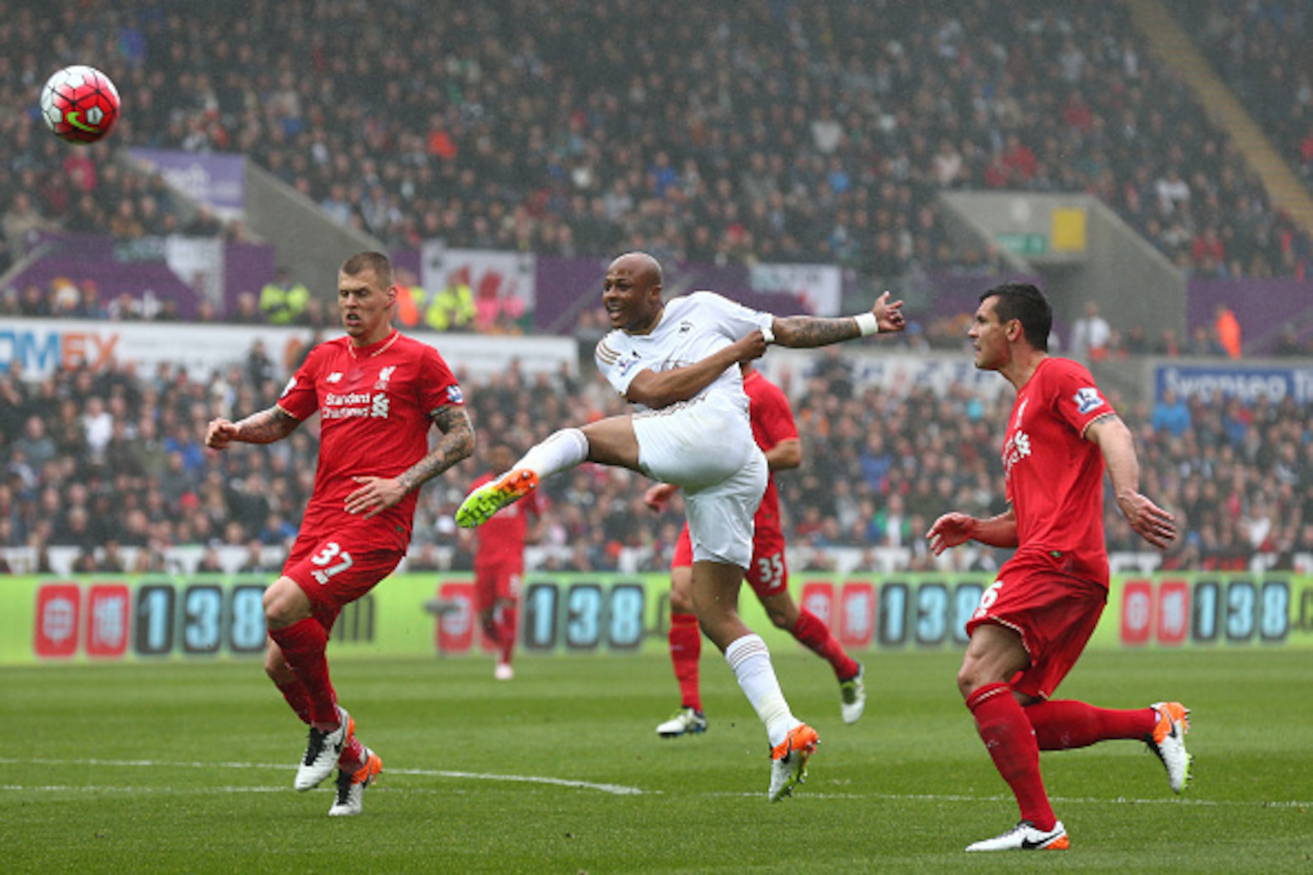 SWANSEA, WALES - MAY 01:  Andre Ayew of Swansea City misses an early chance at goal watched by Martin Skrtel (L) of Liverpool during the Barclays Premier League match between Swansea City and Liverpool at The Liberty Stadium on May 1, 2016 in Swansea, Wal