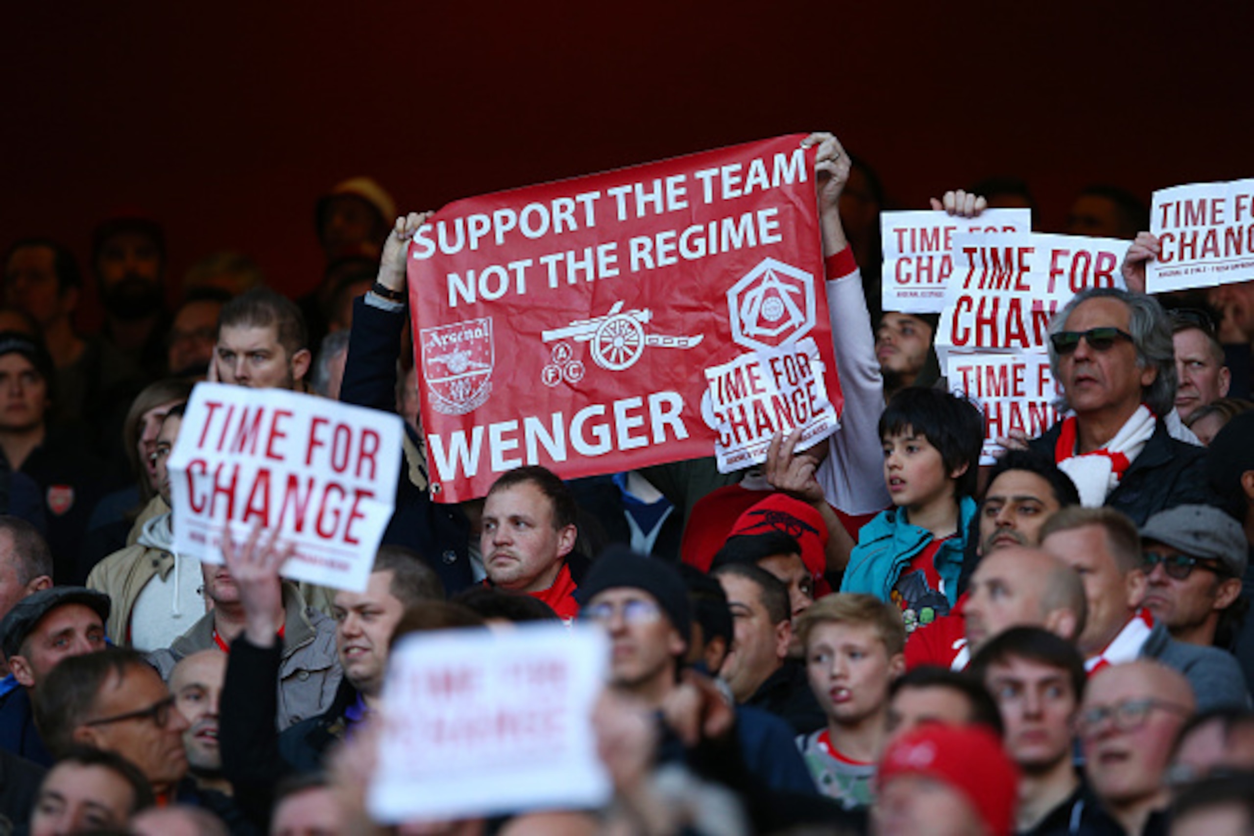 LONDON, ENGLAND - APRIL 30: Arsenal supporters hold banners 'Time For Change' and a message for Arsene Wenger, manager of Arsenal during the Barclays Premier League match between Arsenal and Norwich City at The Emirates Stadium on April 30, 2016 in Londo LONDON, ENGLAND - APRIL 30: Arsenal supporters hold banners 'Time For Change' and a message for Arsene Wenger, manager of Arsenal during the Barclays Premier League match between Arsenal and Norwich City at The Emirates Stadium on April 30, 2016 in Londo