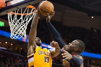 CLEVELAND, OH - APRIL 11: Tristan Thompson #13 of the Cleveland Cavaliers blocks Paul Millsap #4 of the Atlanta Hawks during the second half at Quicken Loans Arena on April 11, 2016 in Cleveland, Ohio. The Cavaliers defeated the Hawks 109-94. NOTE TO USER