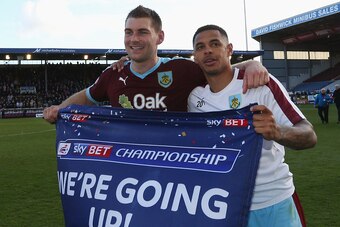 BURNLEY, UNITED KINGDOM - MAY 02:  Sam Vokes (9) and Andre Gray of Burnley (7) celebrate as they are promoted to the Premier League after the Sky Bet Championship match between Burnley and Queens Park Rangers at Turf Moor on May 2, 2016 in Burnley, United