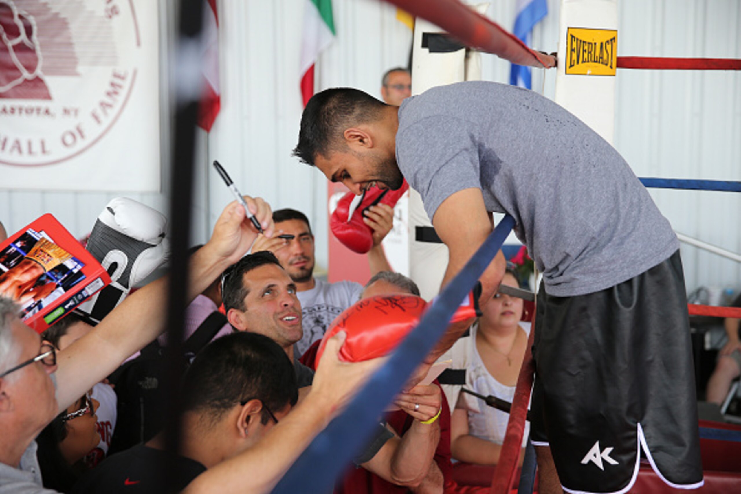 CANASTOTA, NY - JUNE 13: Boxing champion Amir Khan signs autographs for fans after his boxing demo at the International Boxing Hall of Fame induction Weekend of Champions events on June 13, 2015 in Canastota, New York. (Photo by Alex Menendez/Getty Images