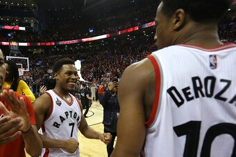 TORONTO, CANADA - MAY 1:  Kyle Lowry #7 of the Toronto Raptors smiles with teammate DeMar DeRozan #10 of the Toronto Raptors after they defeated the Indiana Pacers in Game Seven of the Eastern Conference Quarterfinals during the 2016 NBA Playoffs on May 1