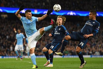 MANCHESTER, ENGLAND - APRIL 26: Sergio Aguero of Manchester City and Casemiro of Real Madrid CF battle for the ball during the UEFA Champions League Semi Final first leg match between Manchester City FC and Real Madrid at the Etihad Stadium on April 26, 2