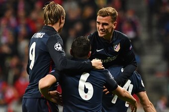 Atletico Madrid's French forward Antoine Griezmann (R) celebrates scoring with his team-mates during the UEFA Champions League semi-final, second-leg football match between FC Bayern Munich and Atletico Madrid in Munich, southern Germany, on May 3, 2016. 