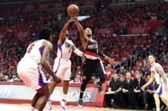 Apr 17, 2016; Los Angeles, CA, USA; Portland Trail Blazers guard Damian Lillard (0) shoots against Los Angeles Clippers guard Chris Paul (3) during the first half in game one of the first round of the NBA Playoffs at Staples Center. Mandatory Credit: Rich