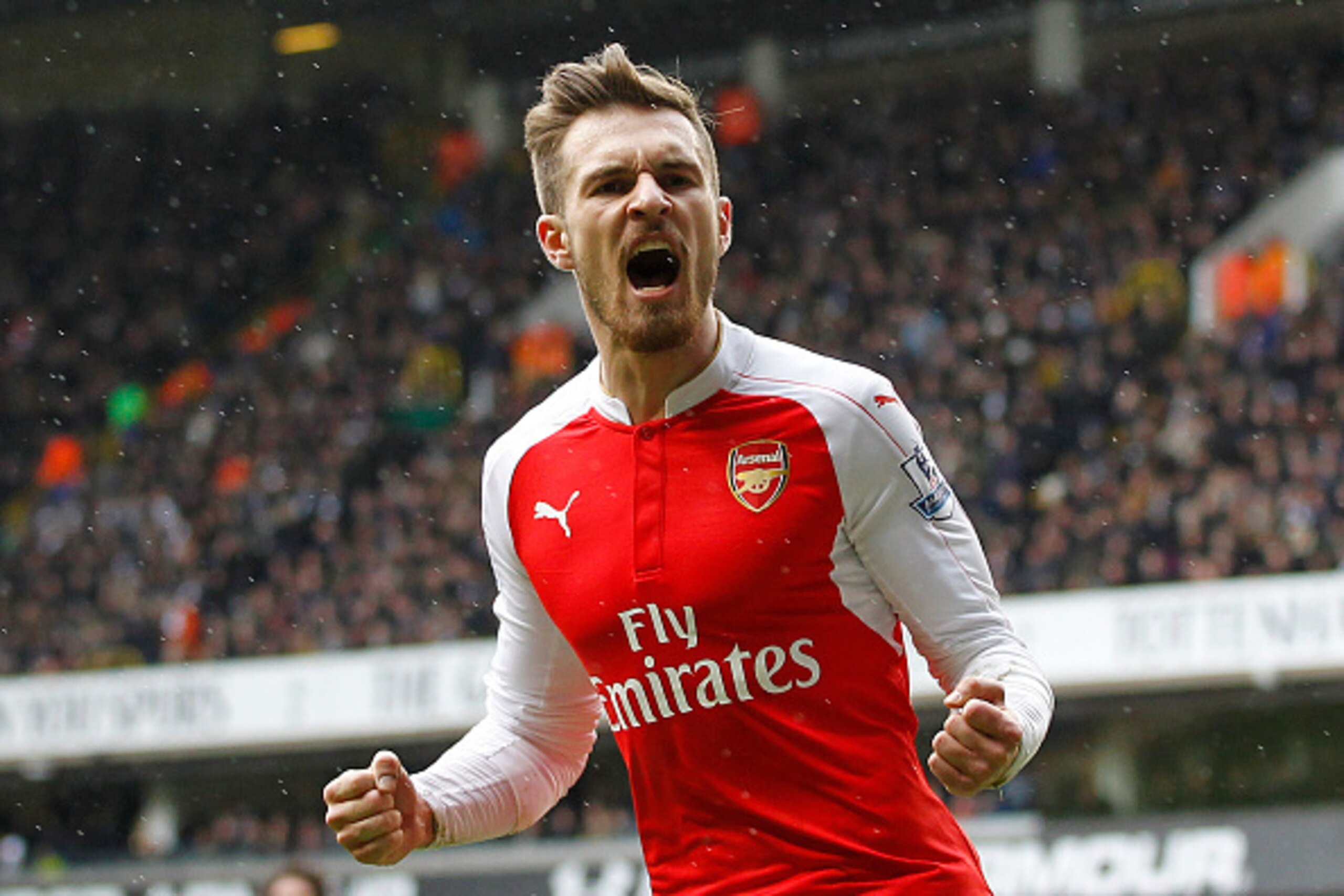 Arsenal's Welsh midfielder Aaron Ramsey celebrates scoring his team's first goal during the English Premier League football match between Tottenham Hotspur and Arsenal at White Hart Lane in London, on March 5, 2016. / AFP / IKIMAGES / IKimages / RESTRICTE