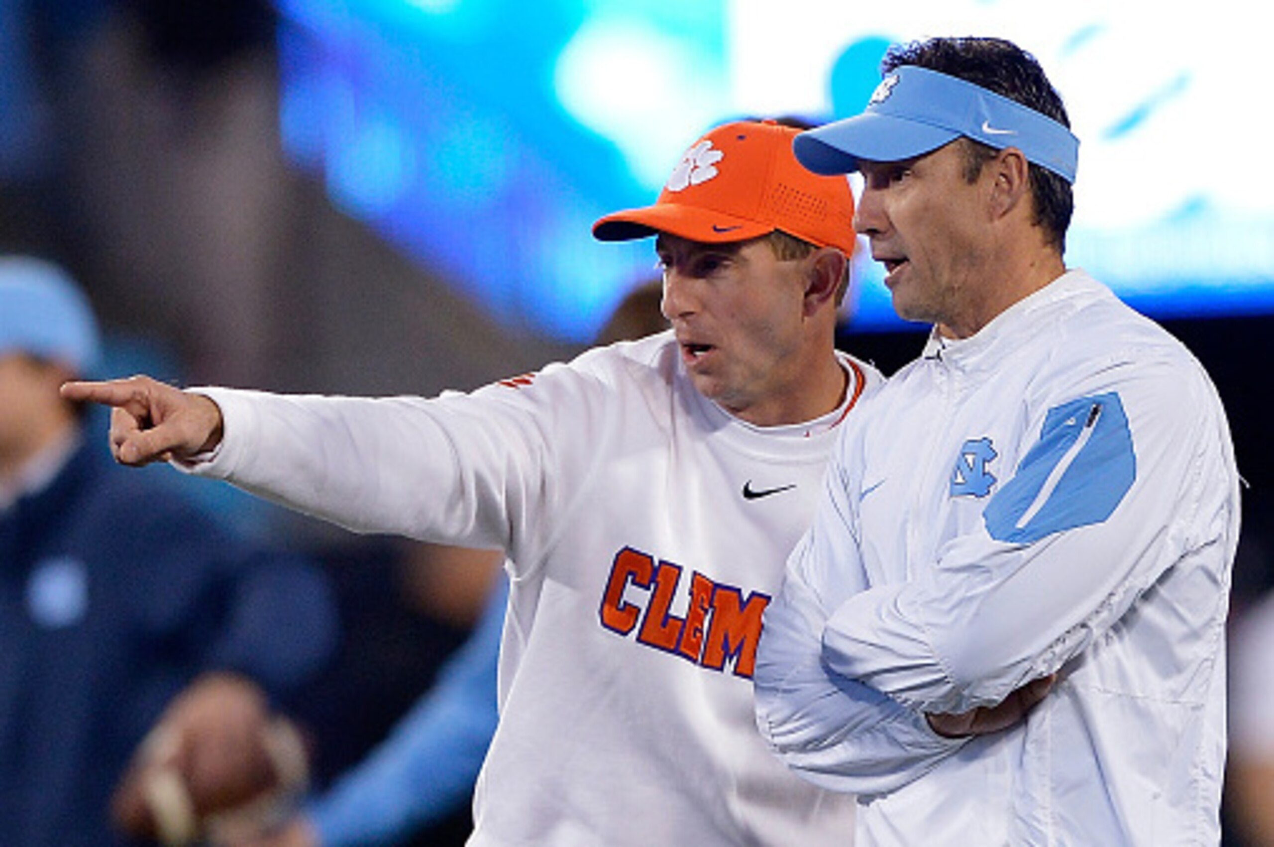 CHARLOTTE, NC - DECEMBER 05: Head coach Larry Fedora of the North Carolina Tar Heels and head coach Dabo Swinney of the Clemson Tigers talk before the Atlantic Coast Conference Football Championship at Bank of America Stadium on December 5, 2015 in Charl CHARLOTTE, NC - DECEMBER 05: Head coach Larry Fedora of the North Carolina Tar Heels and head coach Dabo Swinney of the Clemson Tigers talk before the Atlantic Coast Conference Football Championship at Bank of America Stadium on December 5, 2015 in Charl