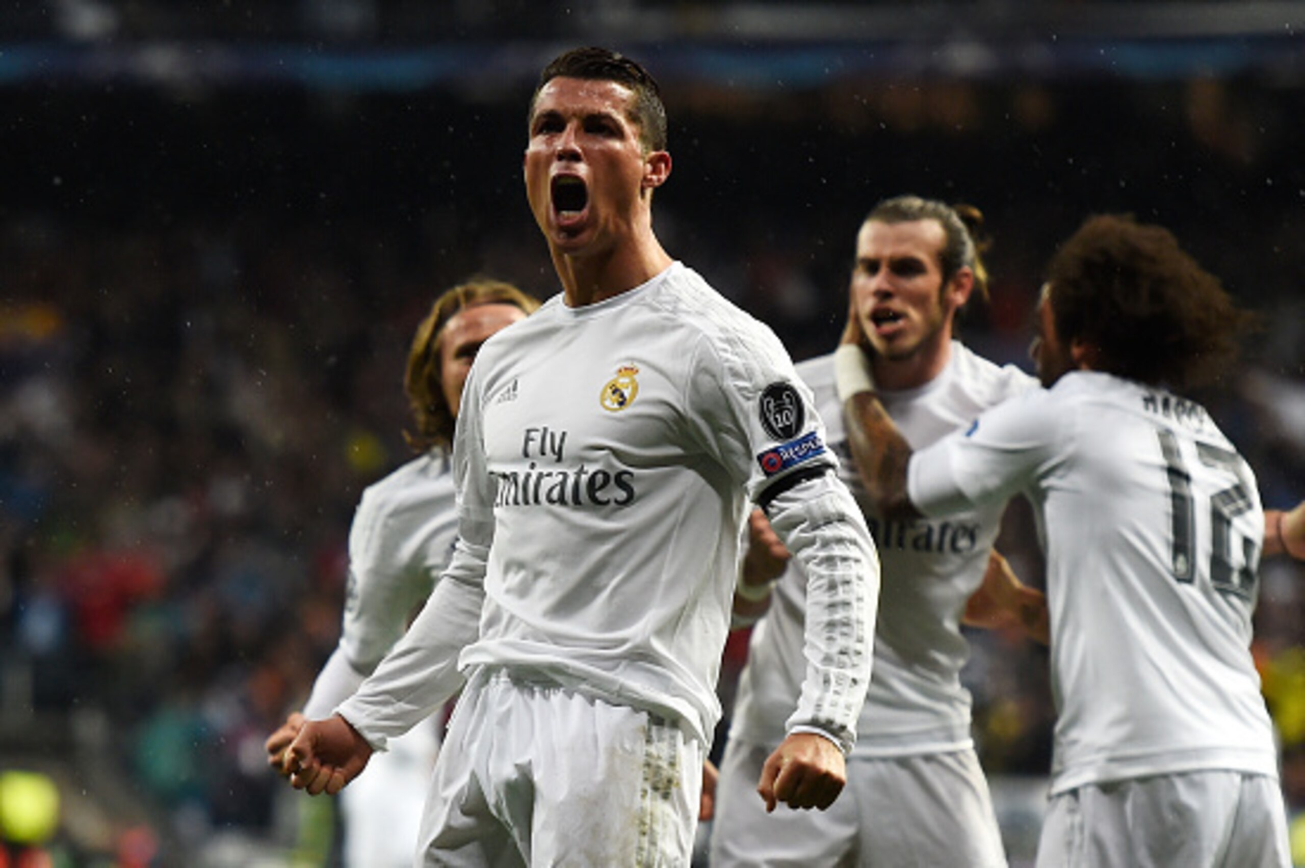 MADRID, SPAIN - APRIL 12:  Cristiano Ronaldo of Real Madrid (7) celebrates with team mates as he scores their second goal during the UEFA Champions League quarter final second leg match between Real Madrid CF and VfL Wolfsburg at Estadio Santiago Bernabeu