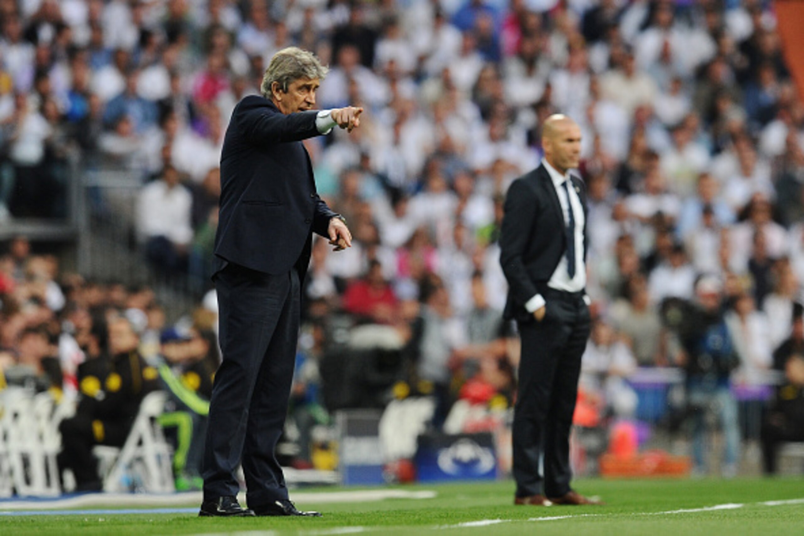 MADRID, SPAIN - MAY 04:  Manuel Pellegrini the manager of Manchester City and Zinedine Zidane the head coach of Real Madrid look on during the UEFA Champions League semi final, second leg match between Real Madrid and Manchester City FC at Estadio Santiag