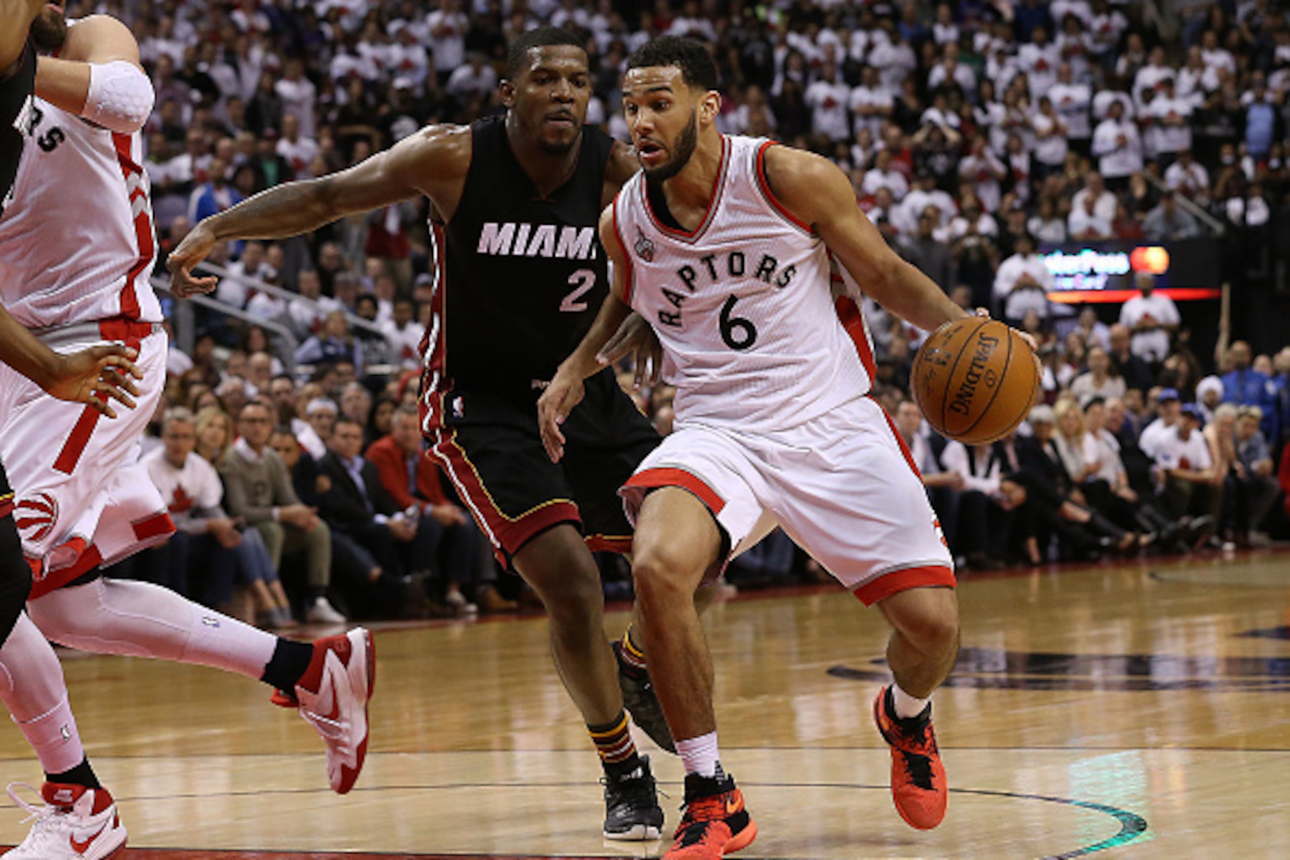 TORONTO, CAN - MAY 3: Cory Joseph #6 of the Toronto Raptors drives to the basket past Joe Johnson #2 of the Miami Heat during Game One of the NBA Eastern Conference Semi Finals at Air Canada Centre on May 3, 2016 in Toronto, Ontario, Canada. NOTE TO USER: