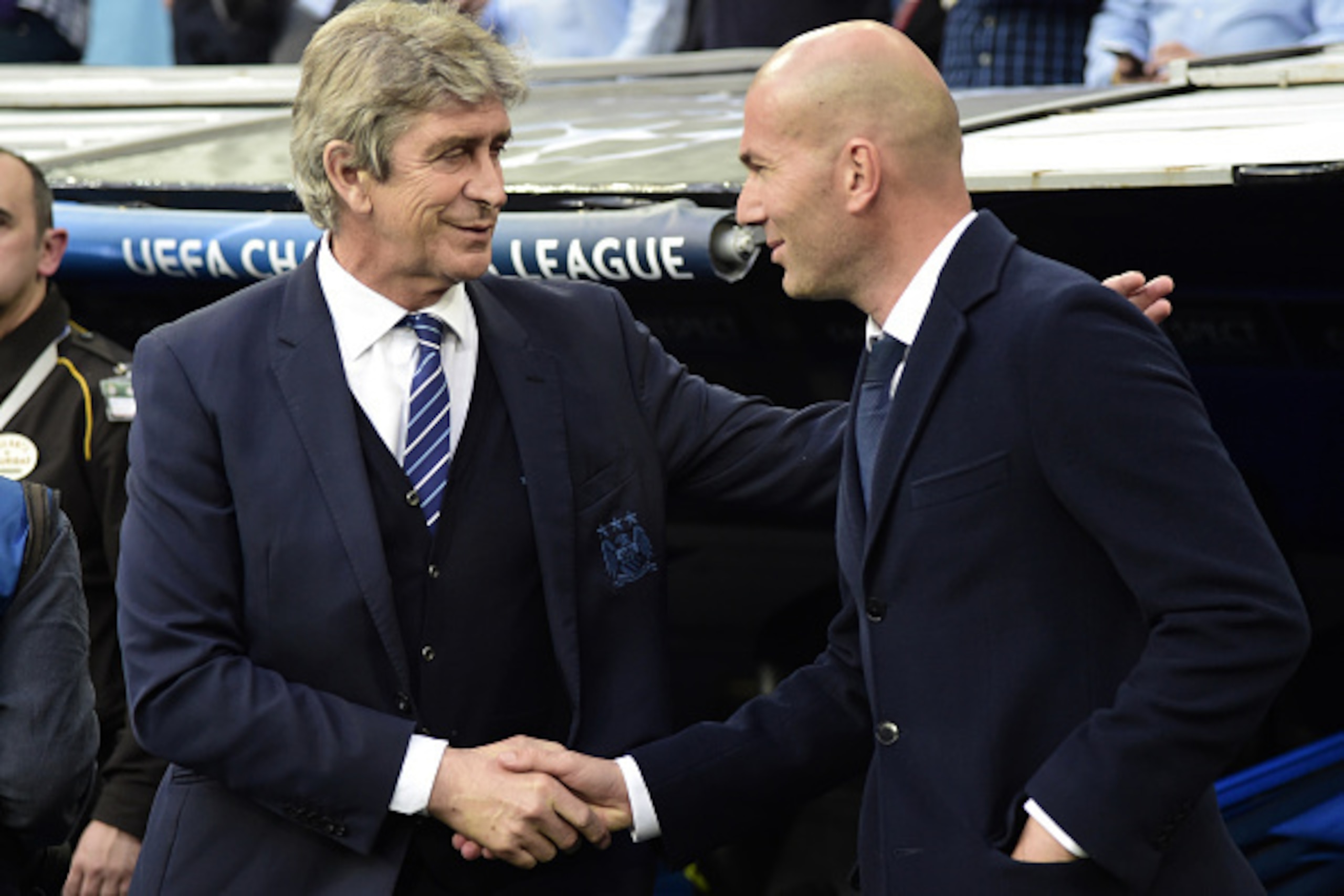 Manchester City's Chilean coach Manuel Pellegrini (L) shakes hands with Real Madrid's French coach Zinedine Zidane during the UEFA Champions League semi-final second leg football match Real Madrid CF vs Manchester City FC at the Santiago Bernabeu stadium 
