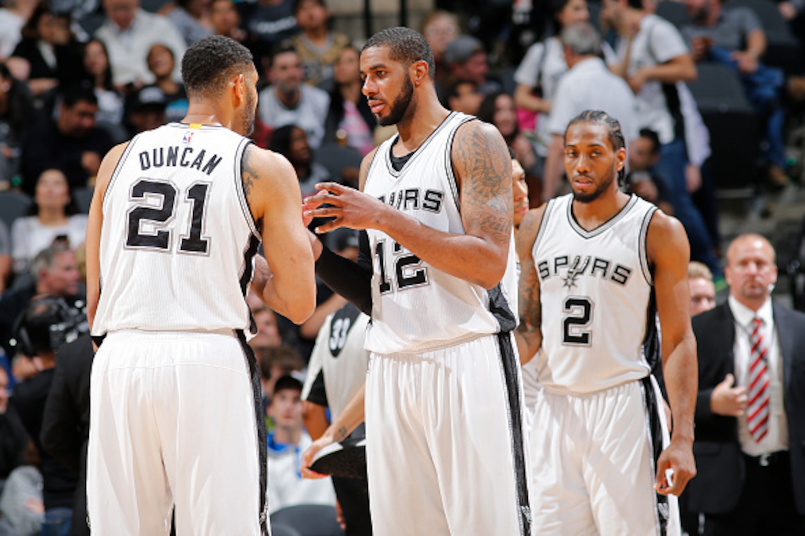 SAN ANTONIO, TX - MAY 2:  Tim Duncan #21 and LaMarcus Aldridge #12 of the San Antonio Spurs talk during the game against the Oklahoma City Thunder in Game Two of the Western Conference Semifinals during the 2016 NBA Playoffs on May 2, 2016 at the AT&T Cen