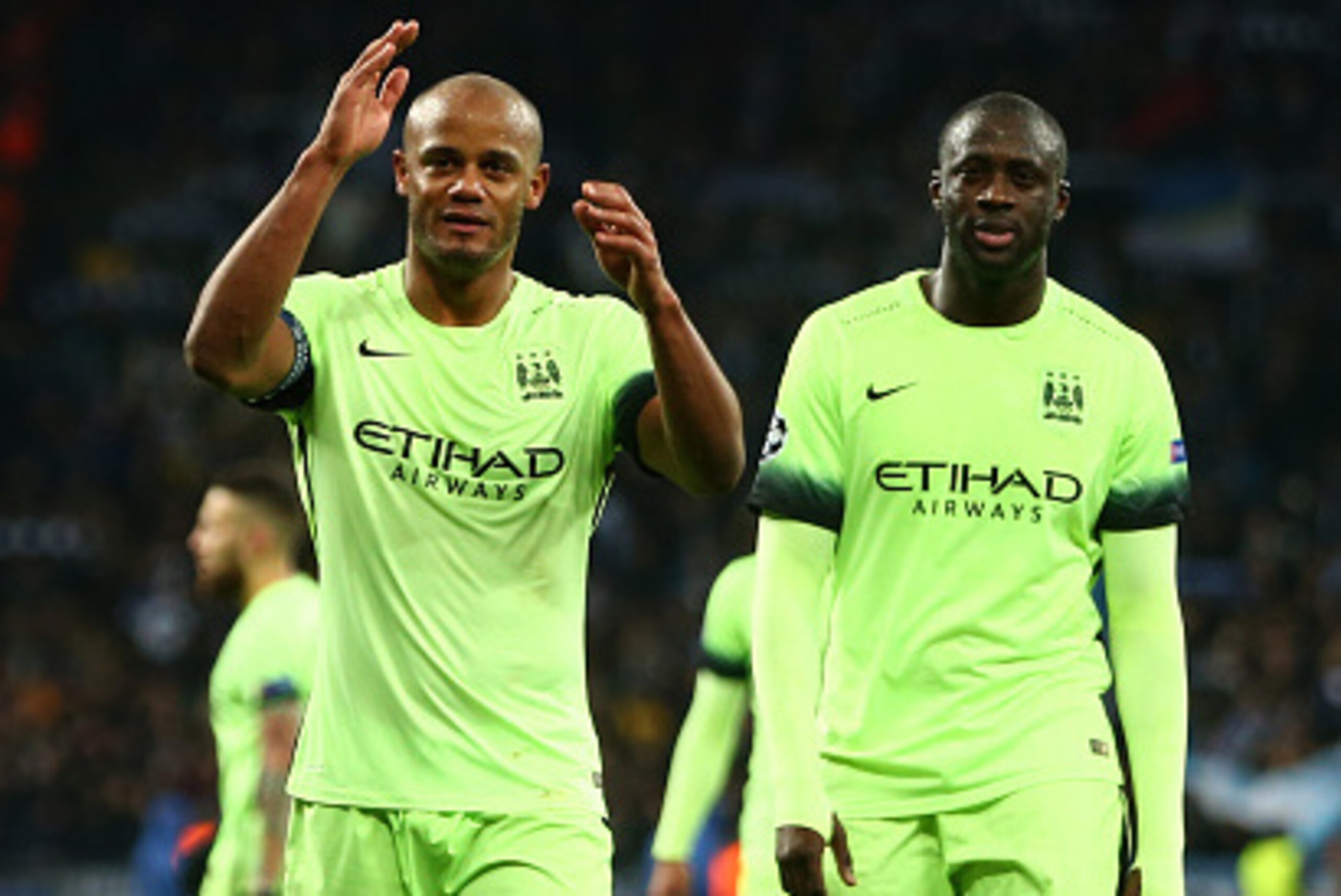 KIEV, UKRAINE - FEBRUARY 24:  (L-R) Vincent Kompany and Yaya Toure of Manchester City applaud the travelling fans following their team's 3-1 victory during the UEFA Champions League round of 16, first leg match between FC Dynamo Kyiv and Manchester City F
